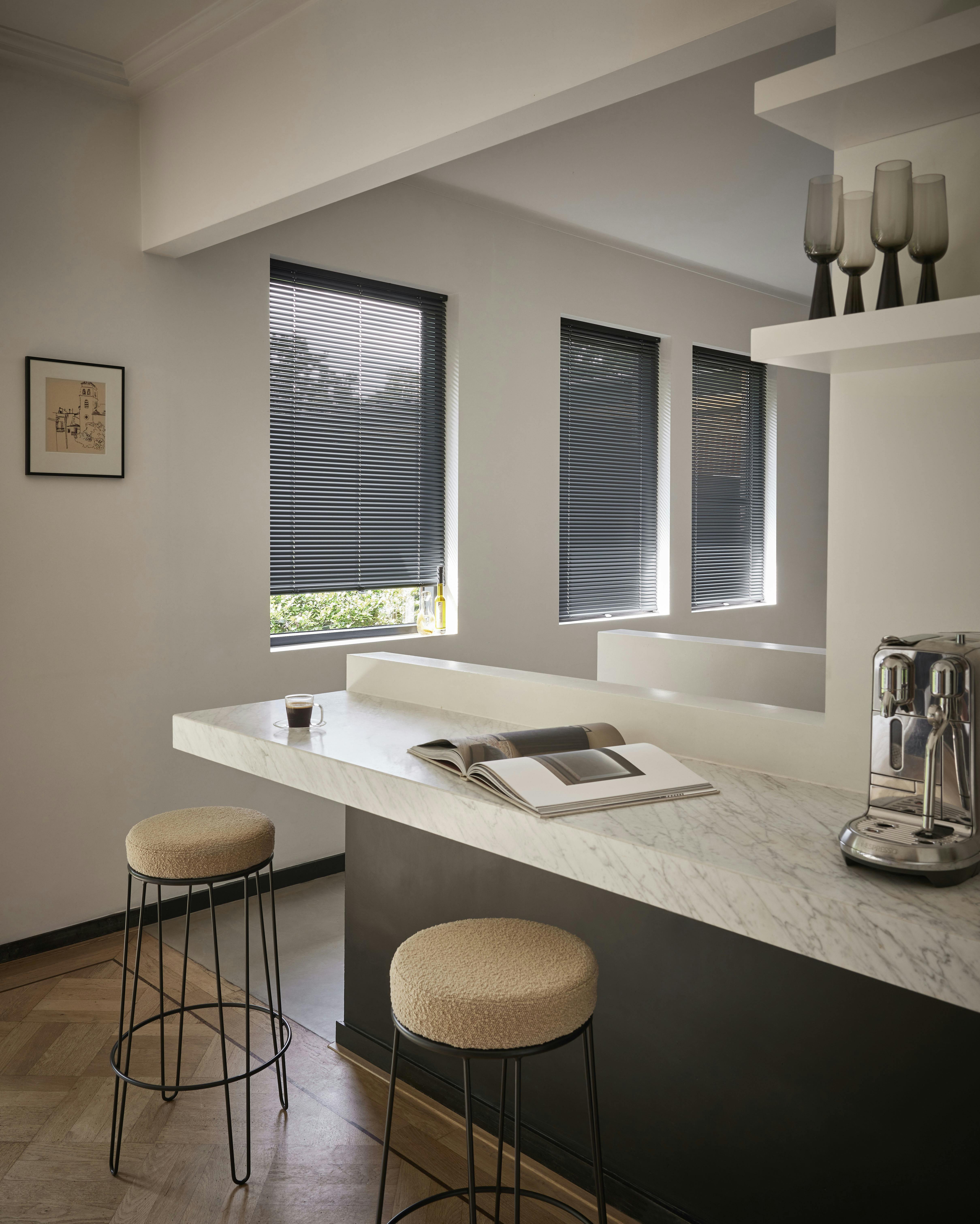 Dark grey venetian blinds on kitchen windows 
