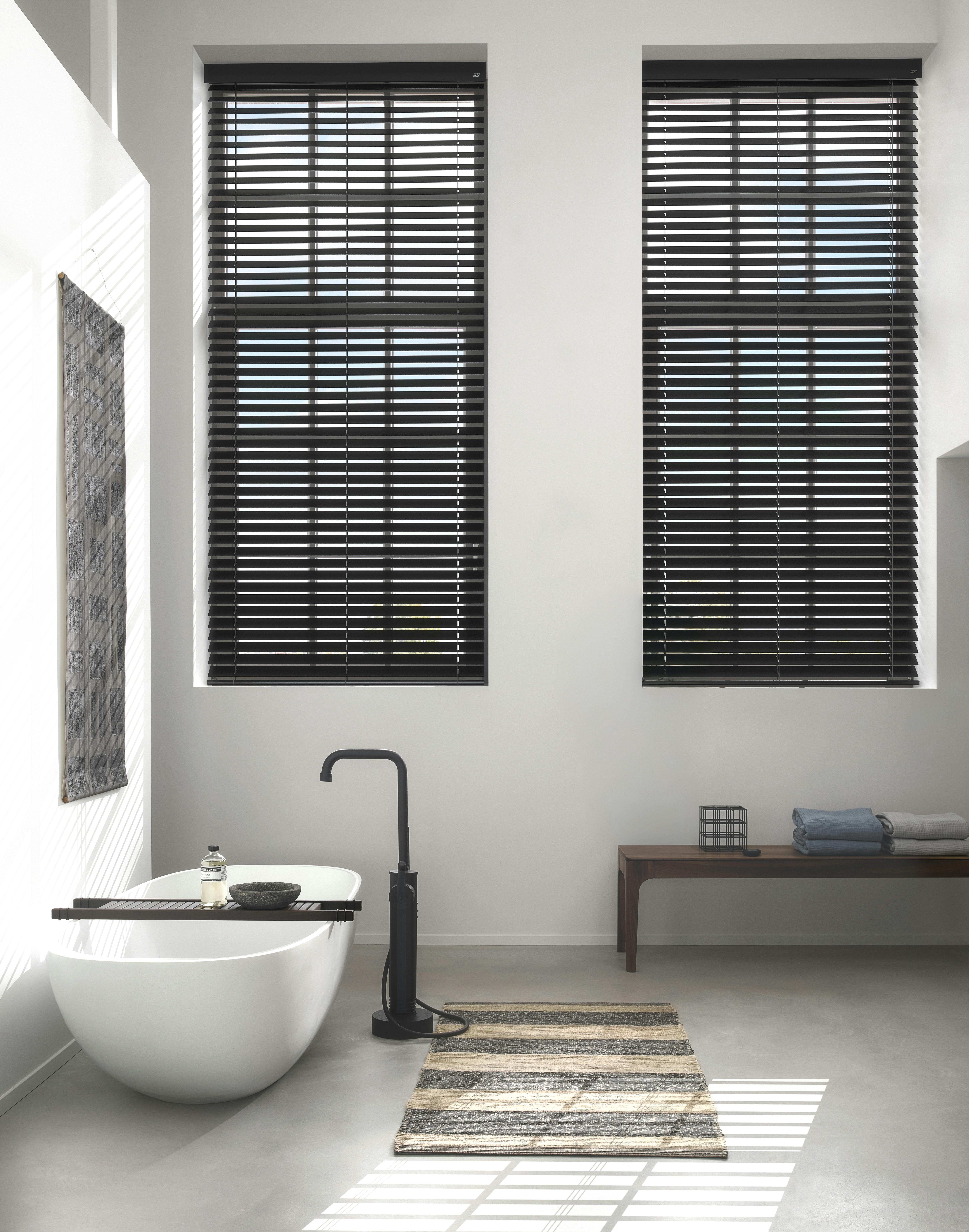 Black wood blinds on large bathroom windows