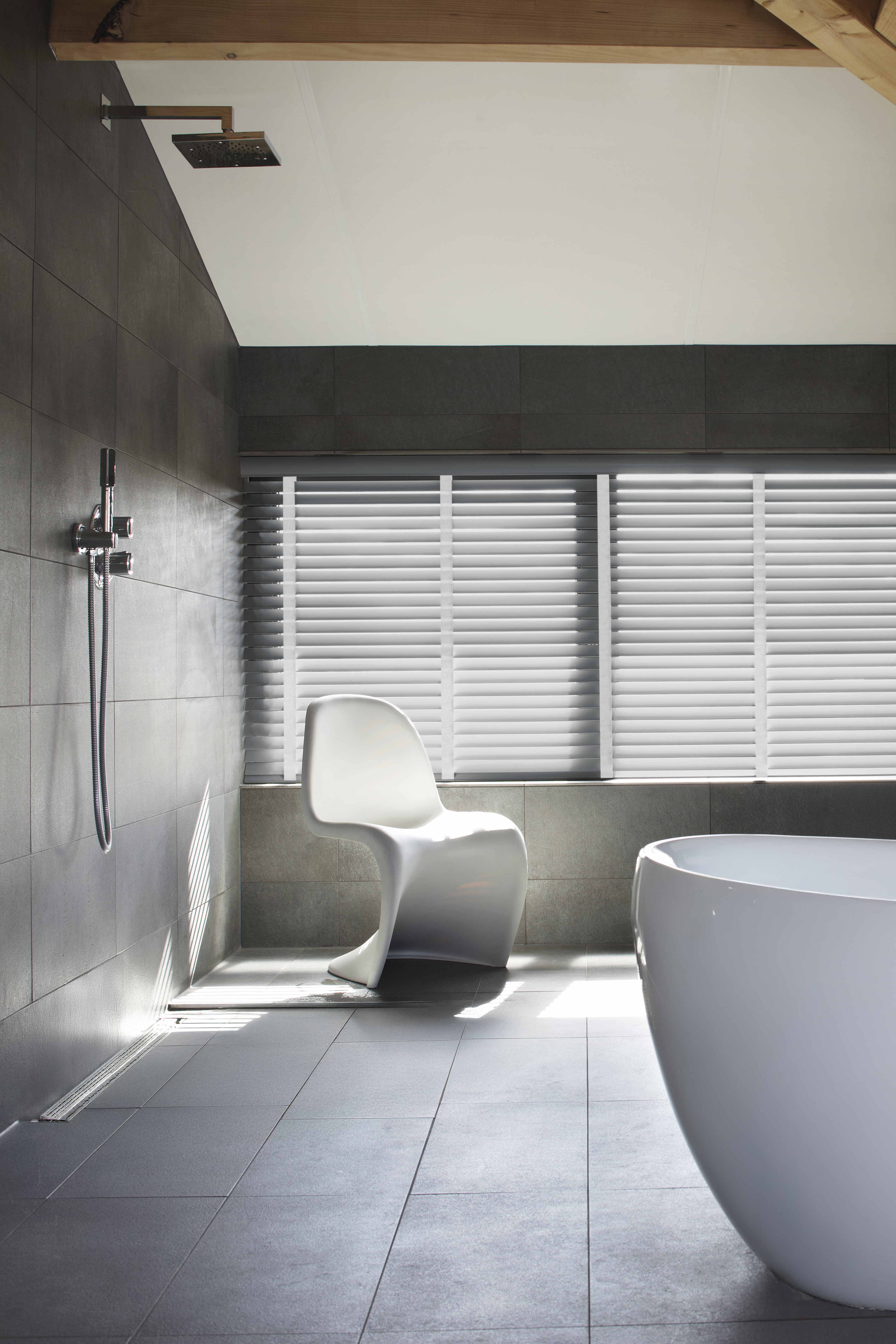 Grey wood blinds with white woven tape in a sleek modern bathroom 