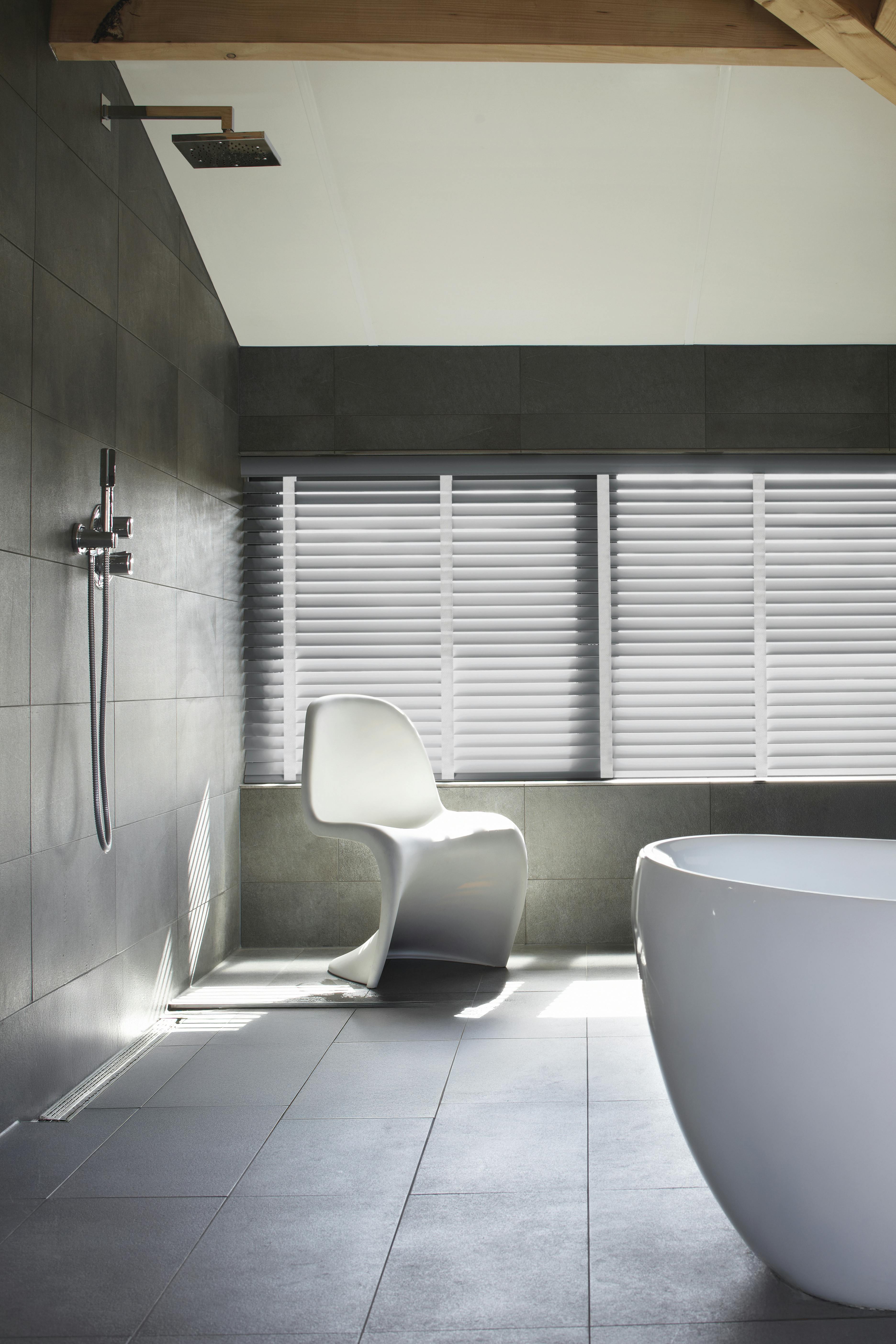 Grey wood blinds with white woven tape in a sleek modern bathroom 