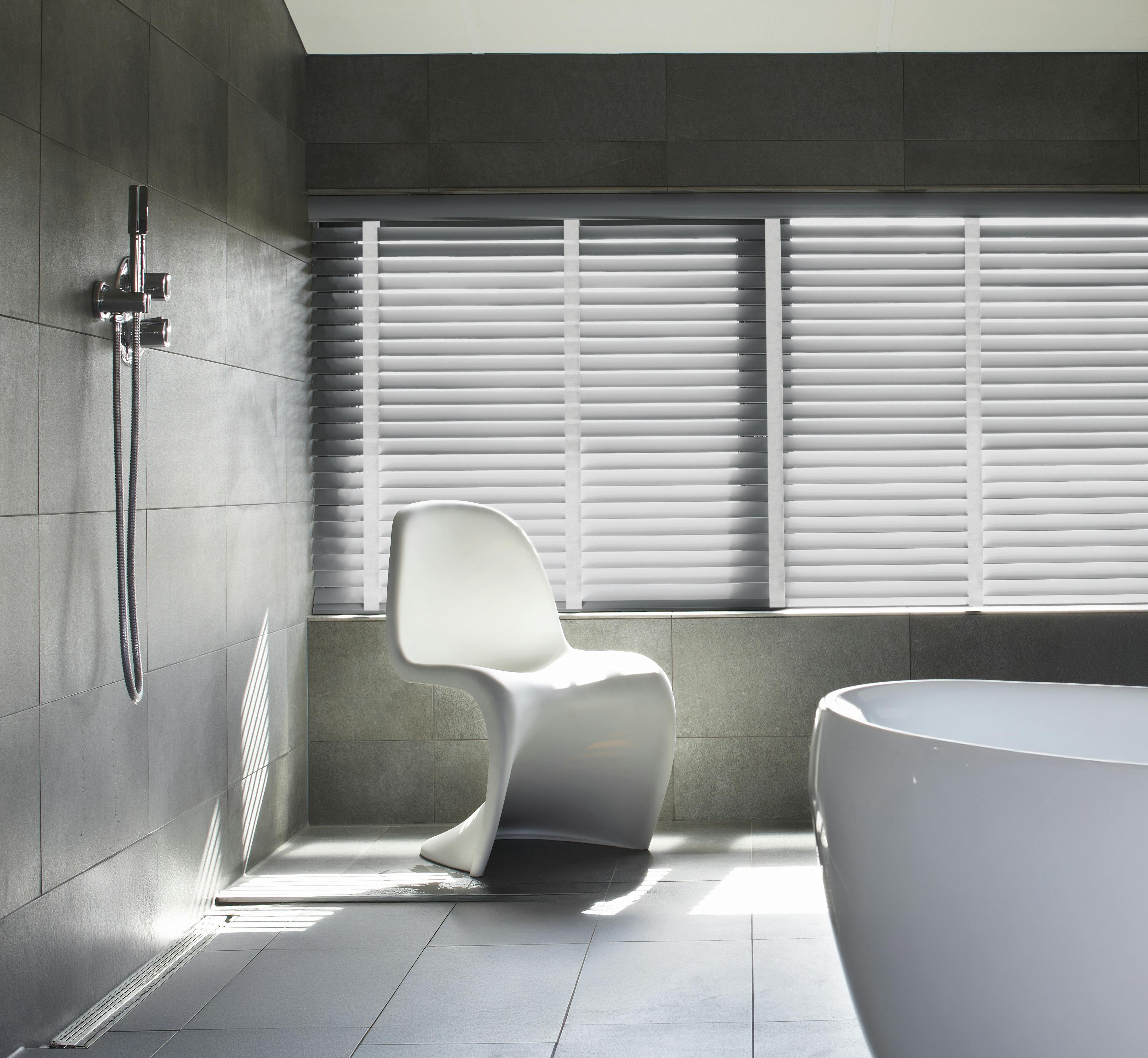 Grey wood blinds with white woven tape in a sleek modern bathroom