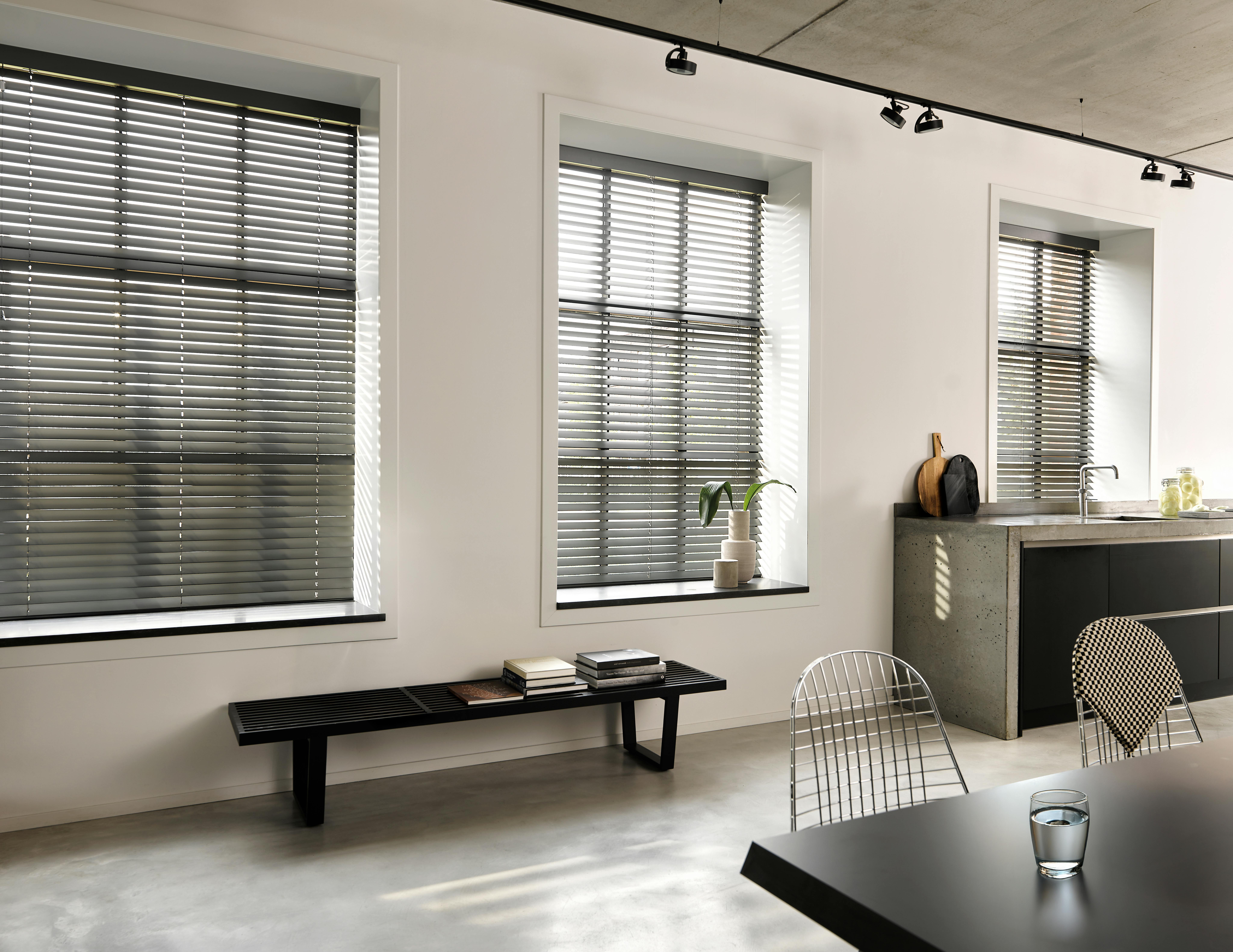 Black wood blinds in a modern kitchen and dining room
