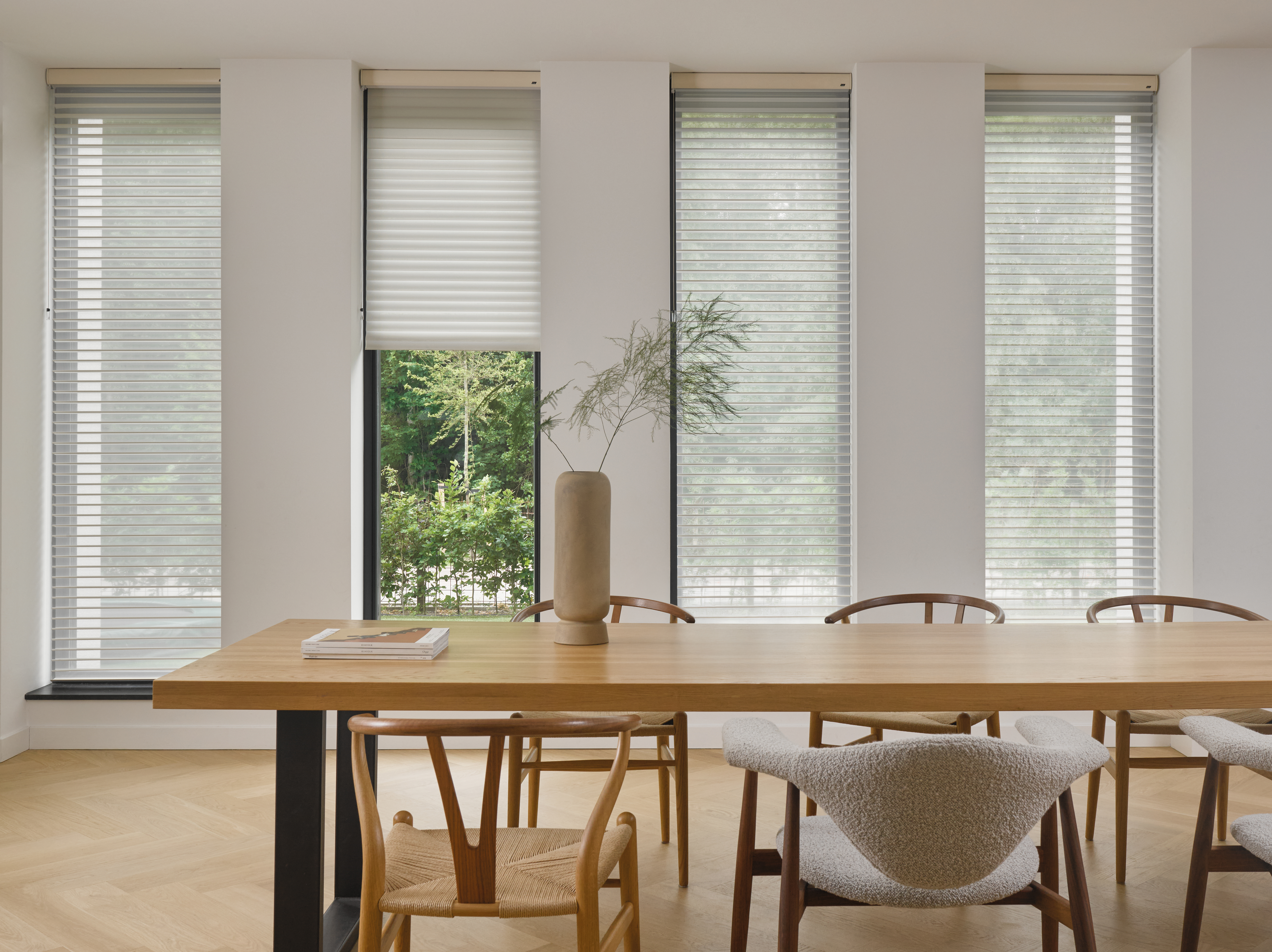 White silhouette shades on windows in a dining room 