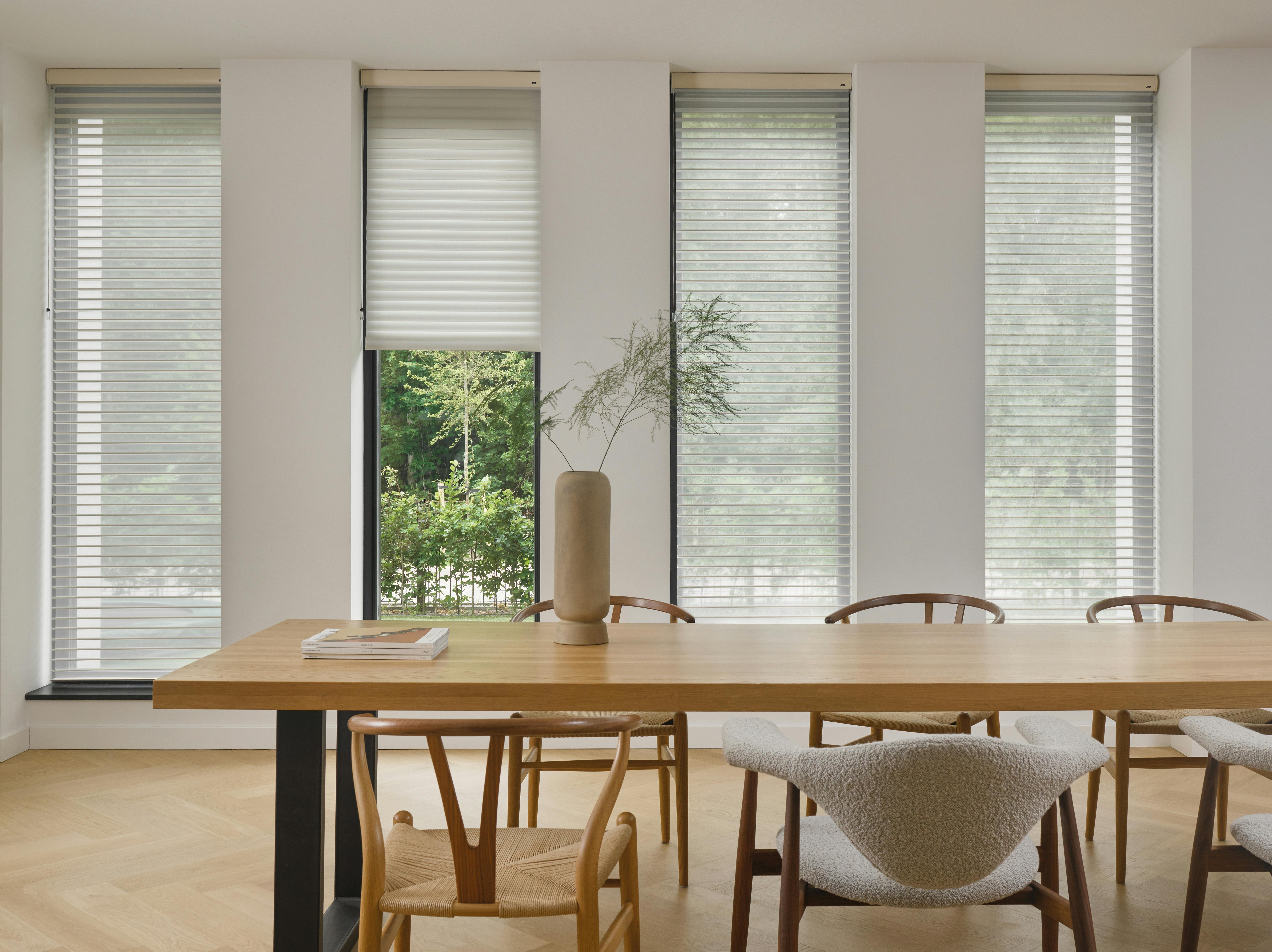 White silhouette shades on windows in a dining room 