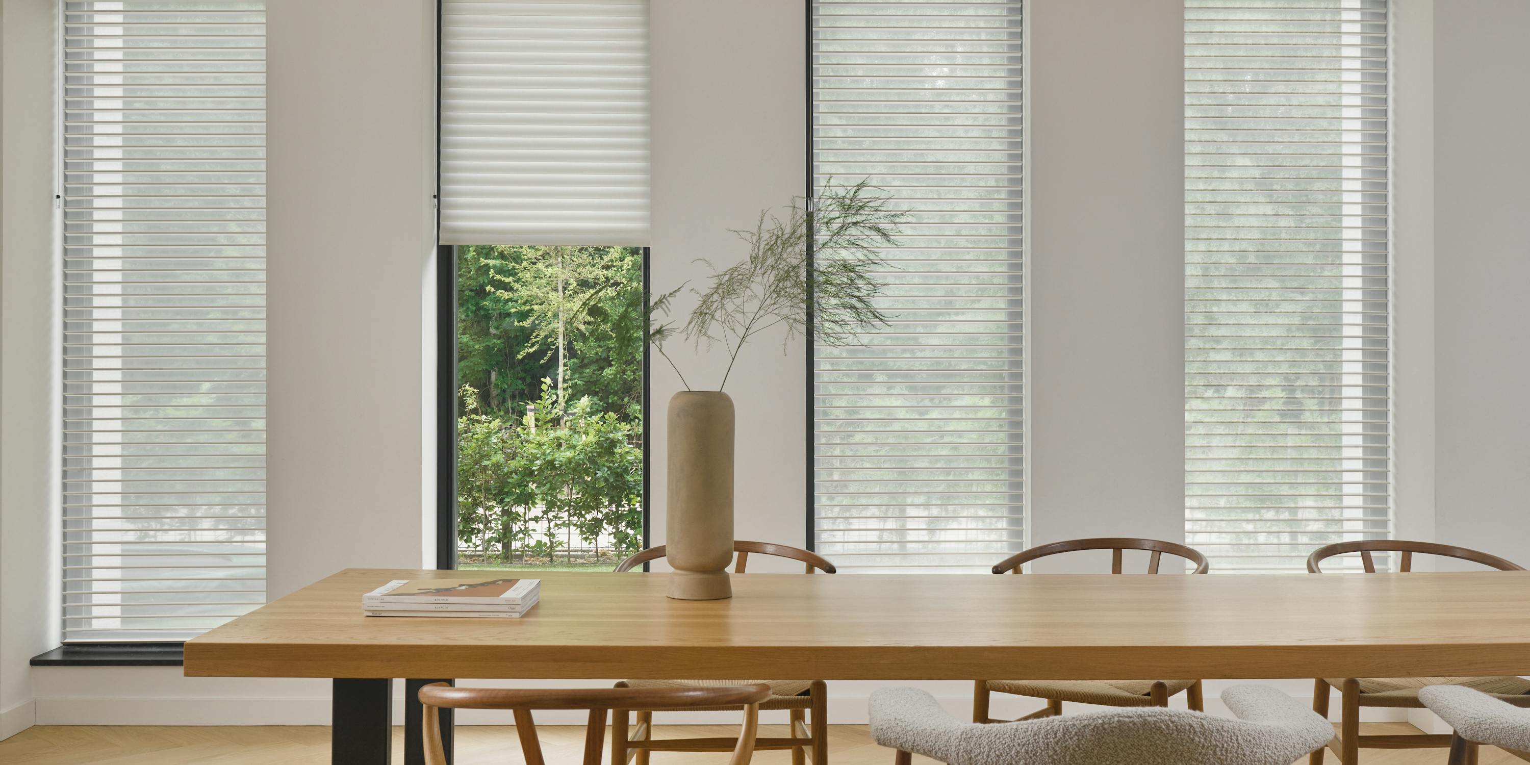 White silhouette shades on windows in a dining room