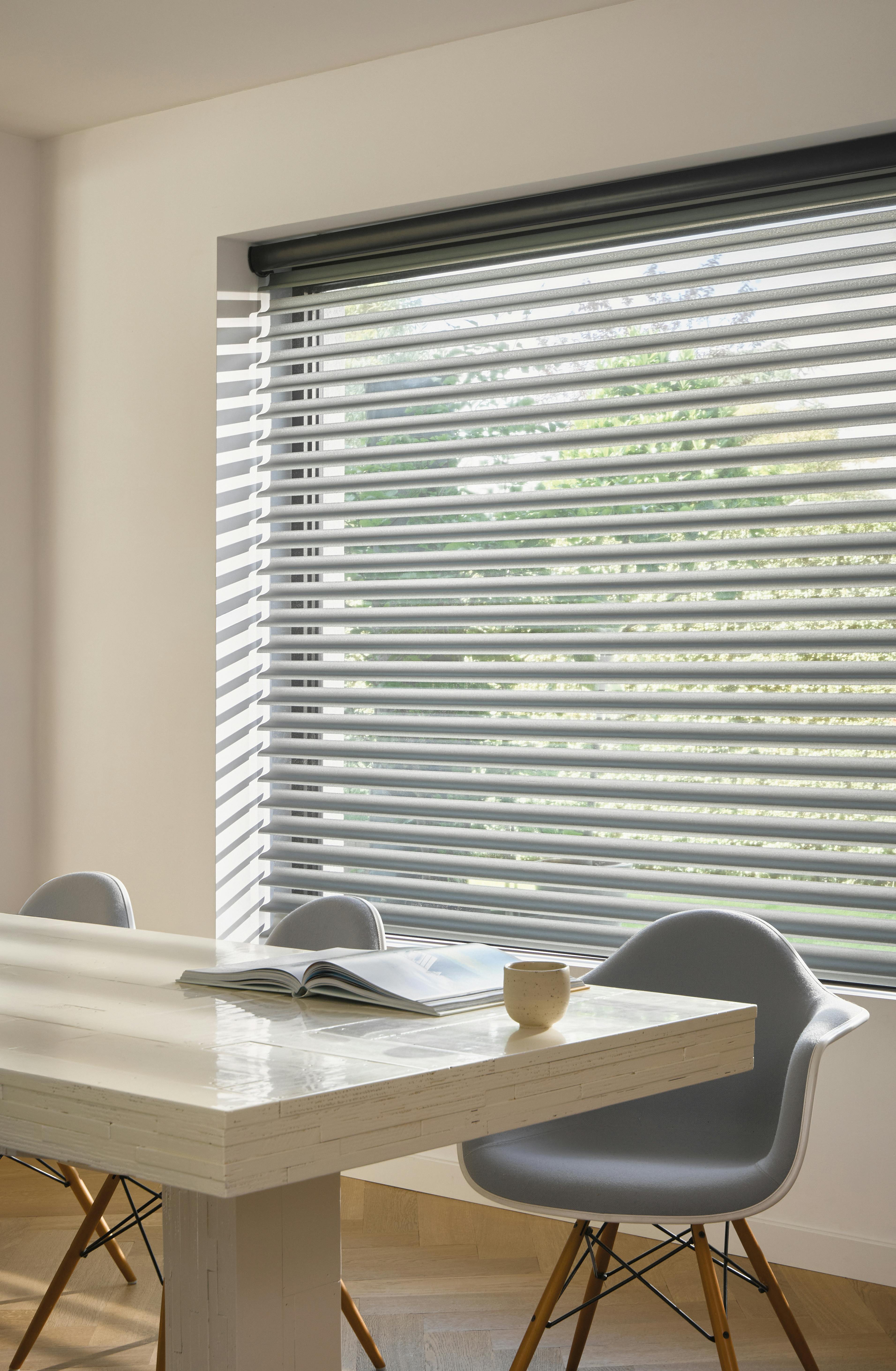 Grey silhouette shades on a dining room window 