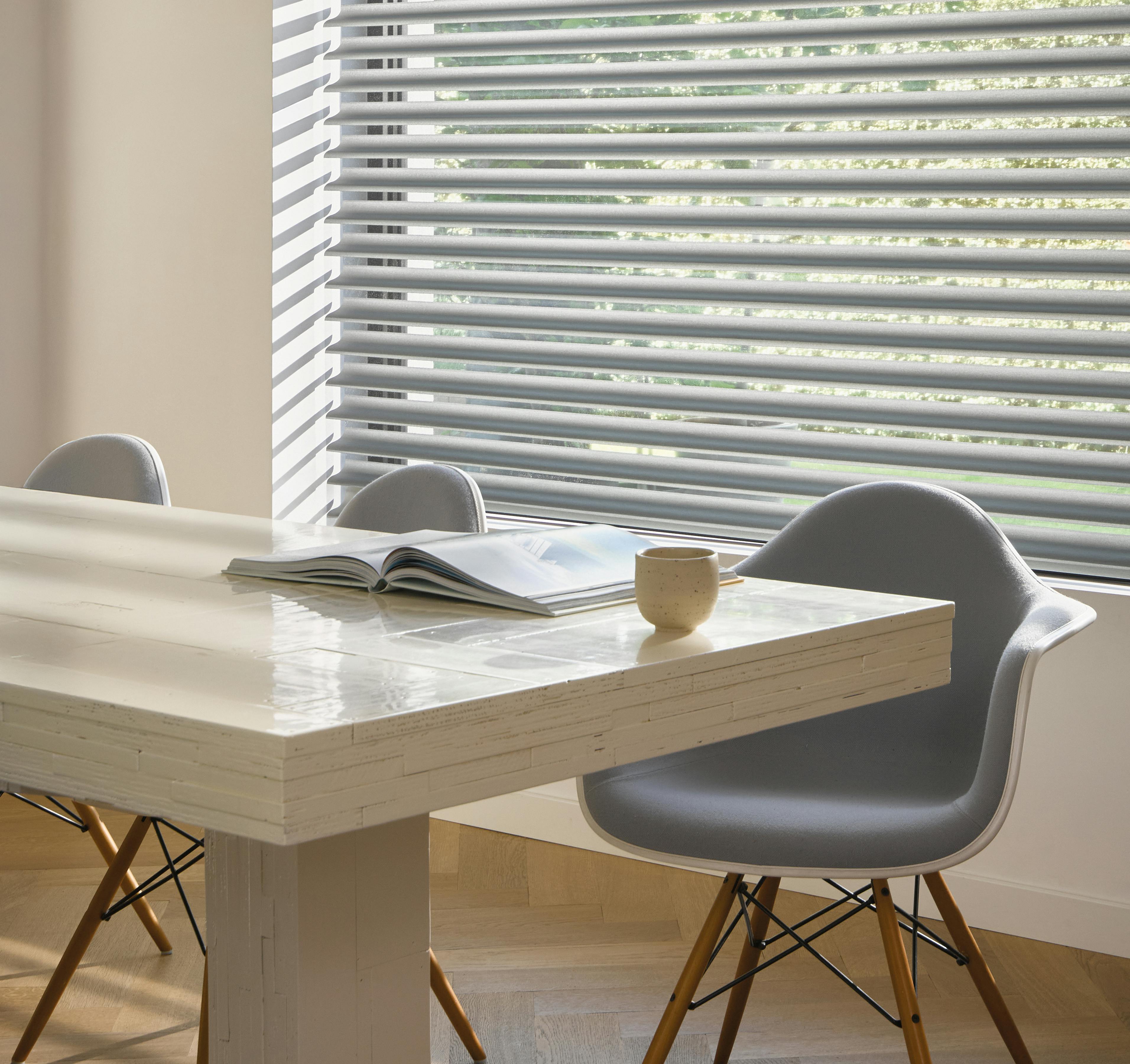 Grey silhouette shades on a dining room window