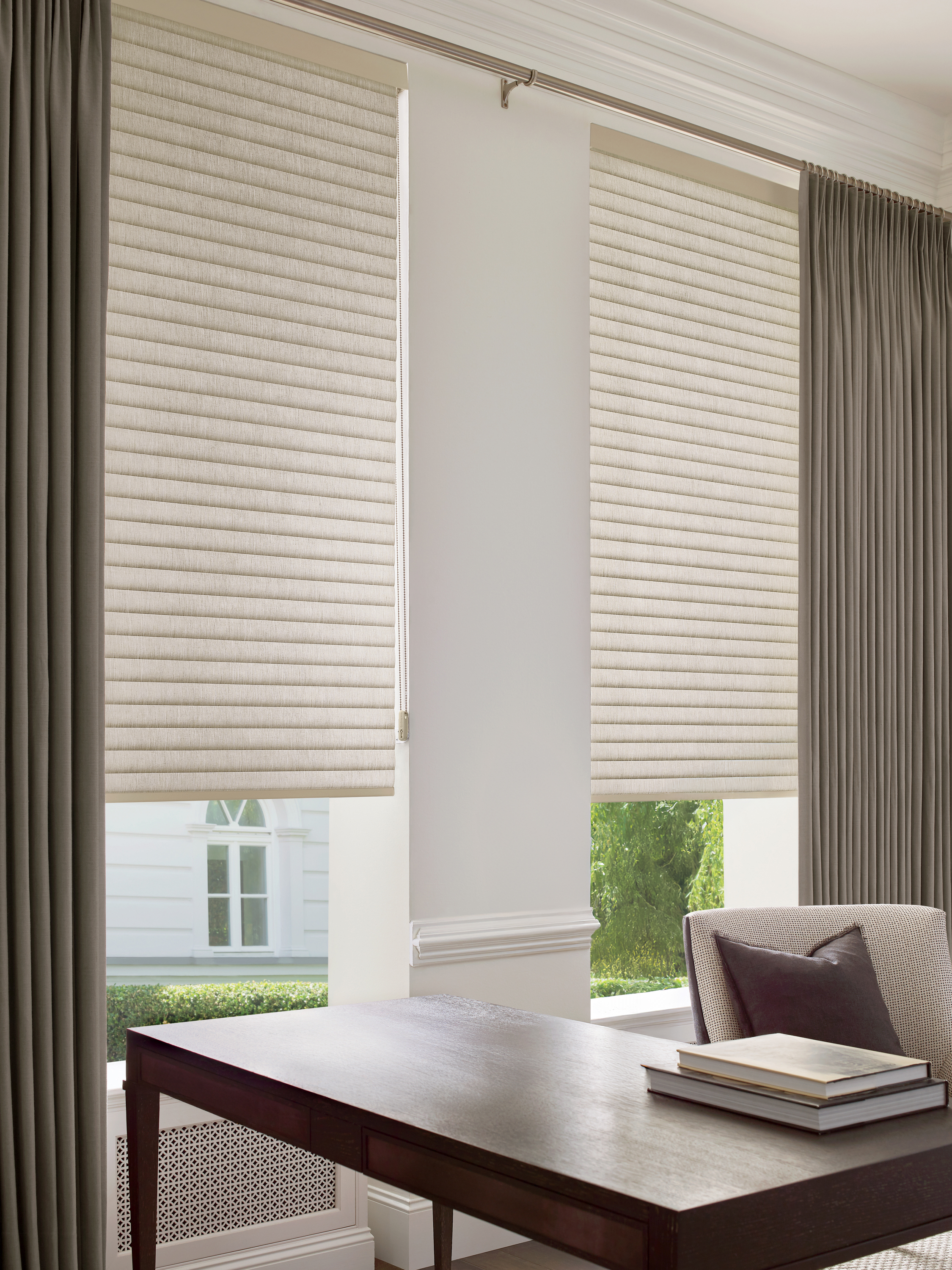 Cream sonnette shades layered with brown curtains in an office 