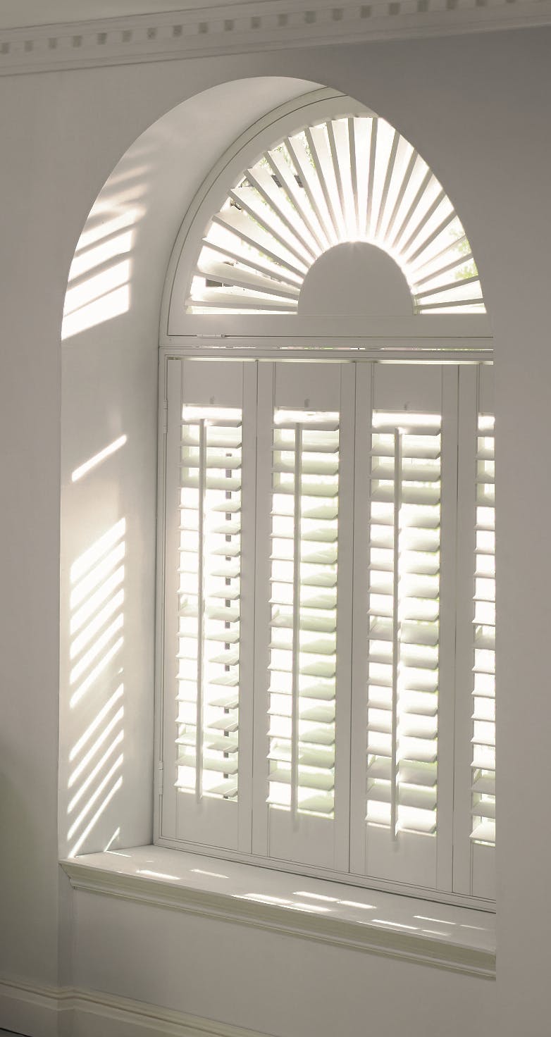 White shutters on an arched window