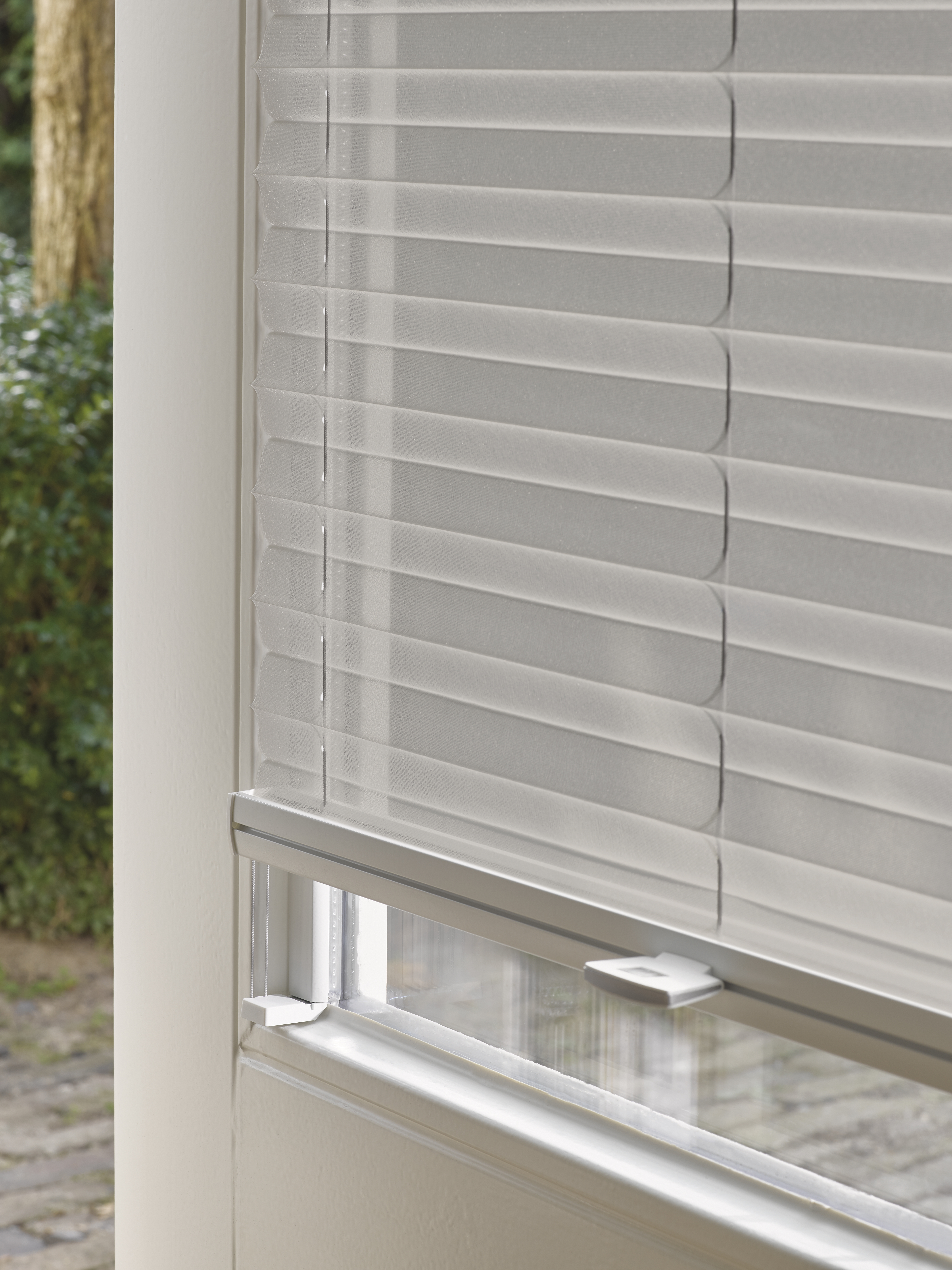 Closeup of light grey Plisse shades with Trufit 