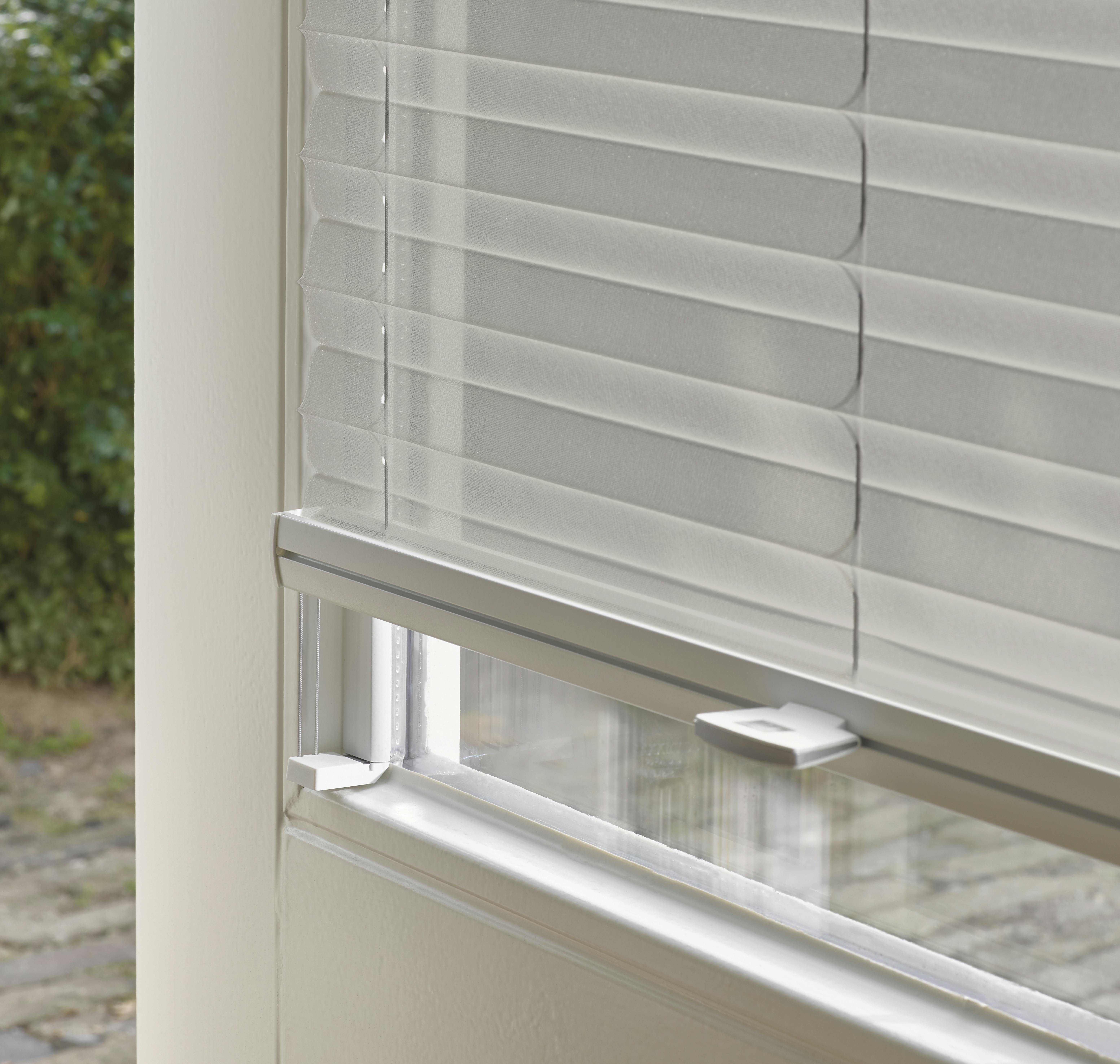 Closeup of light grey Plisse shades with Trufit