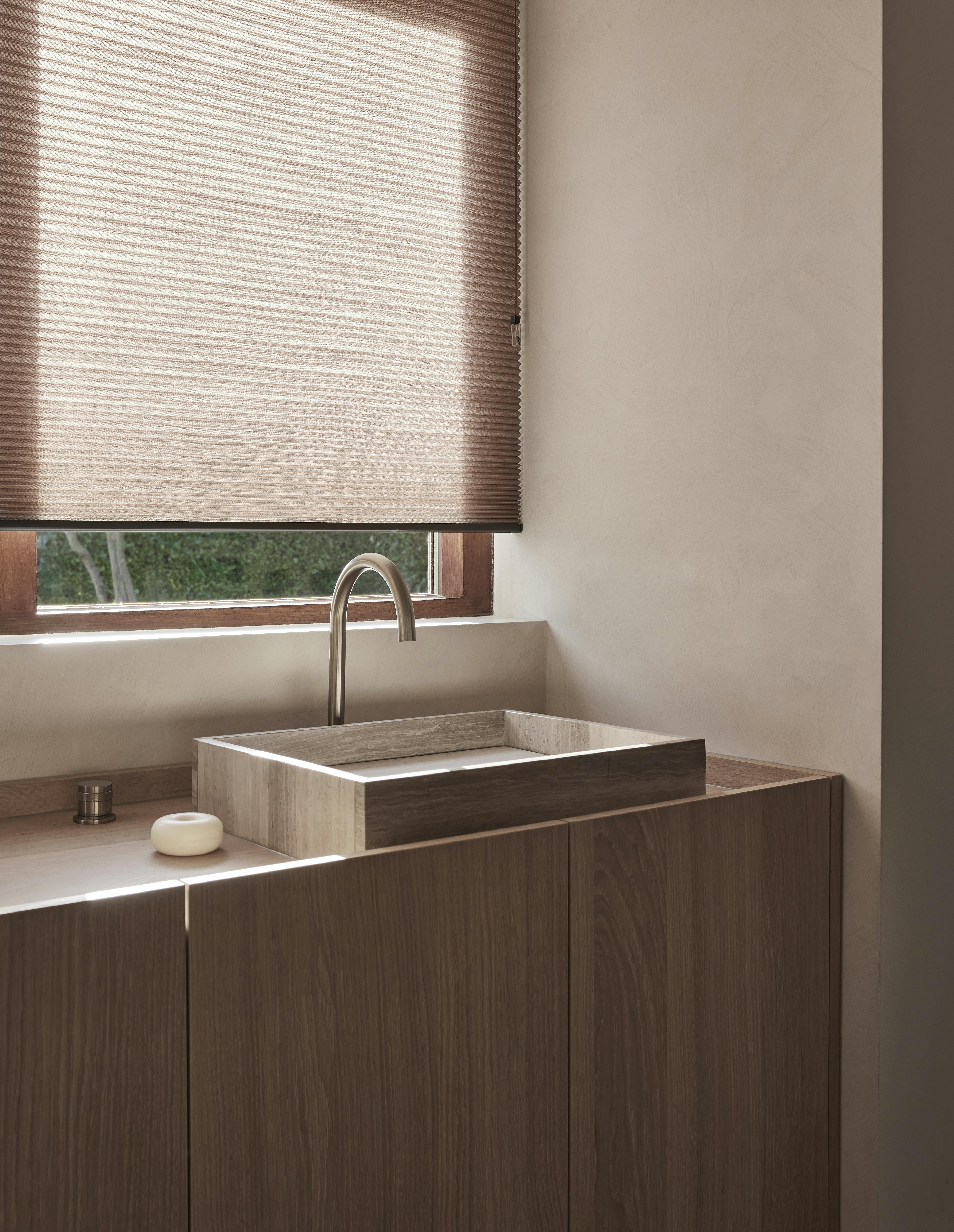 Pink duette shades on a bathroom sink window with TruFit solution