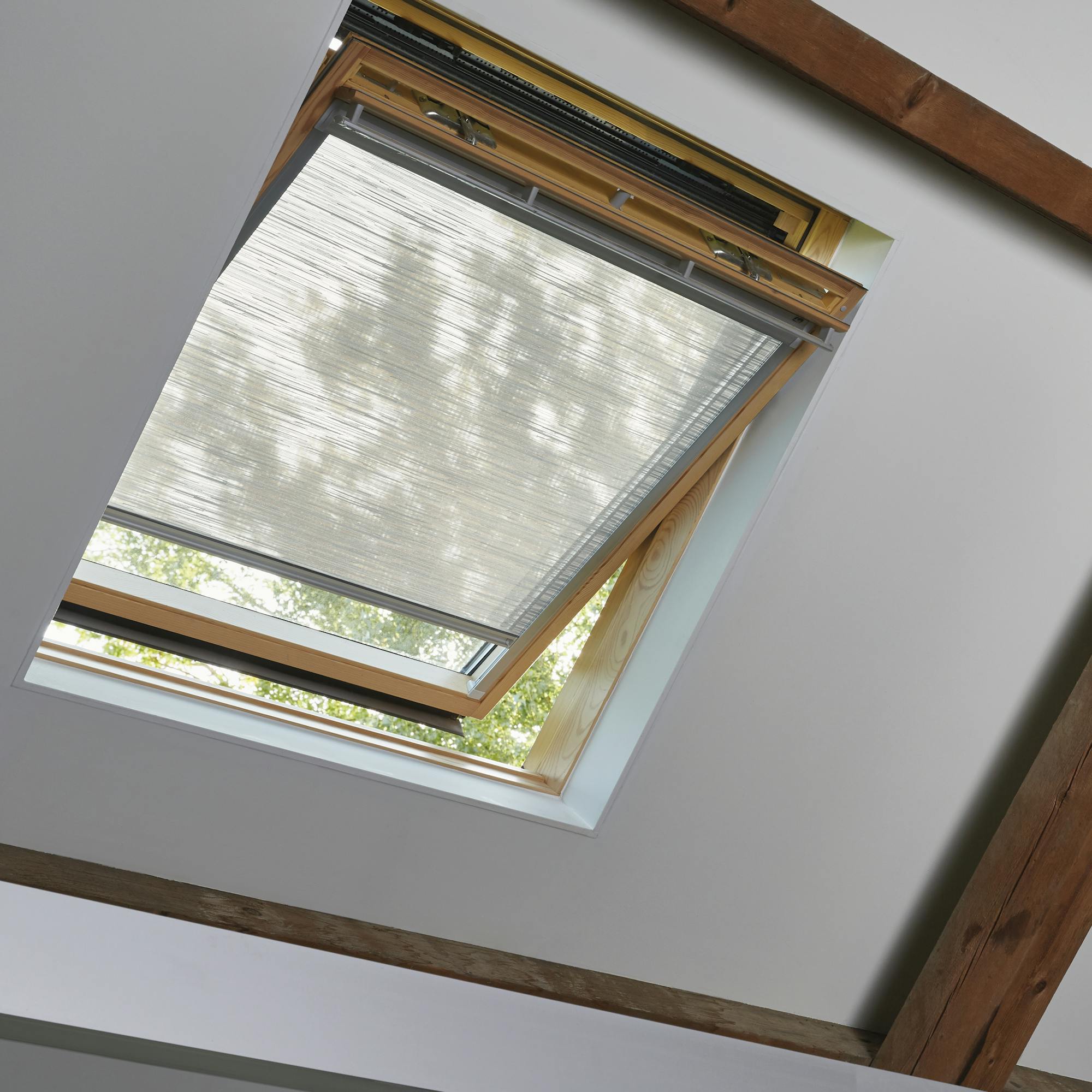 Light grey roller blinds on skylight windows