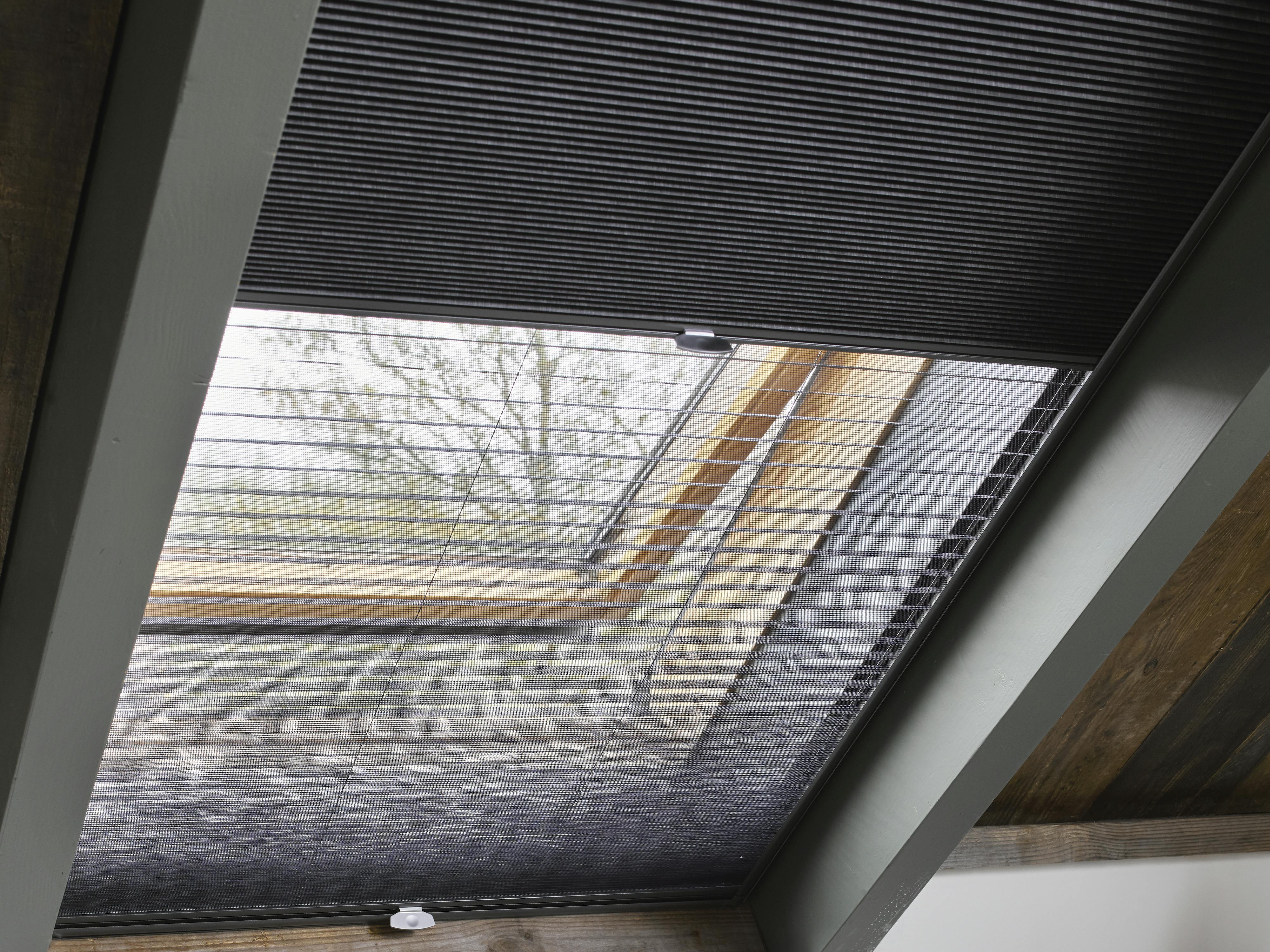 Dark grey duette shades on skylight windows
