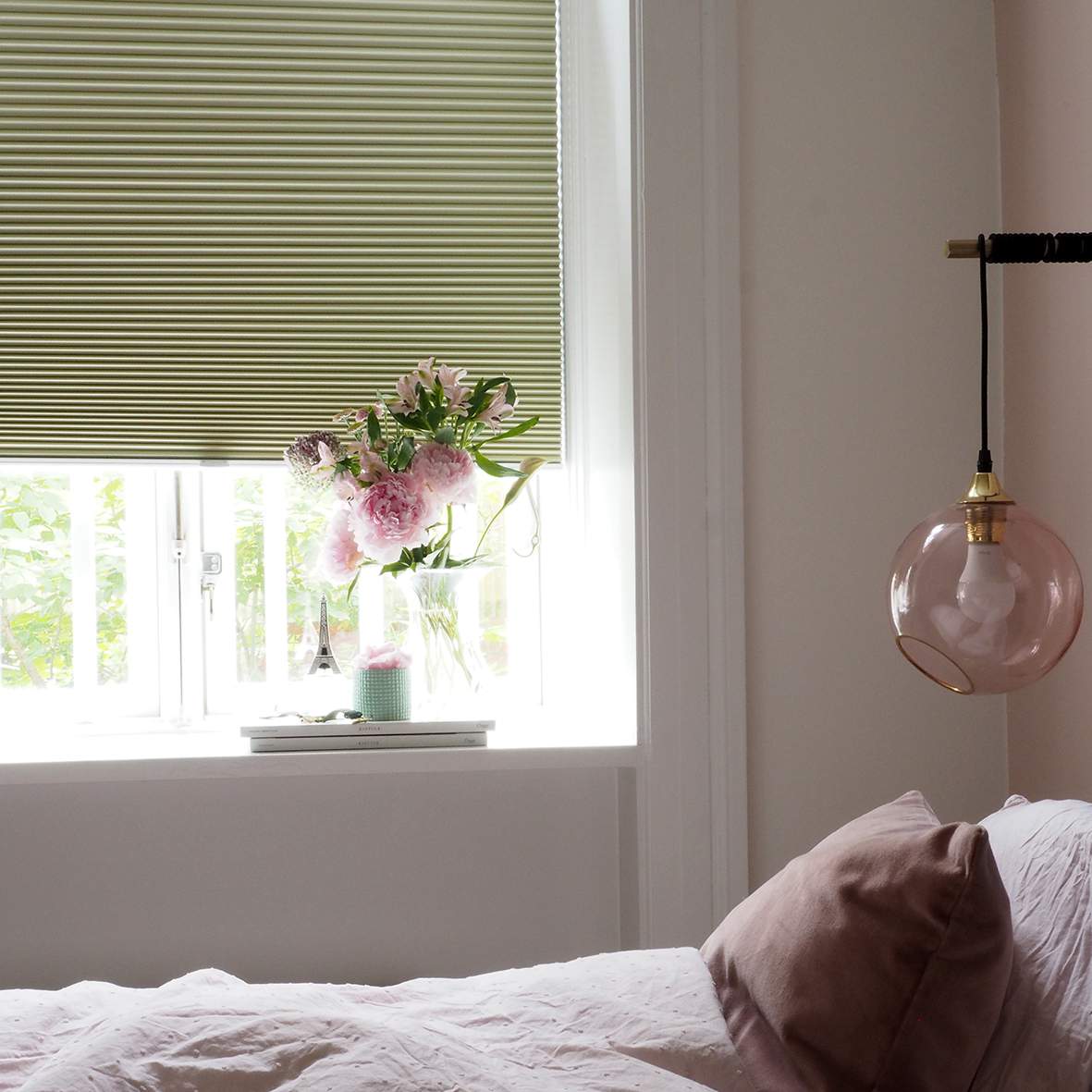 Green duette shades in a bedroom 