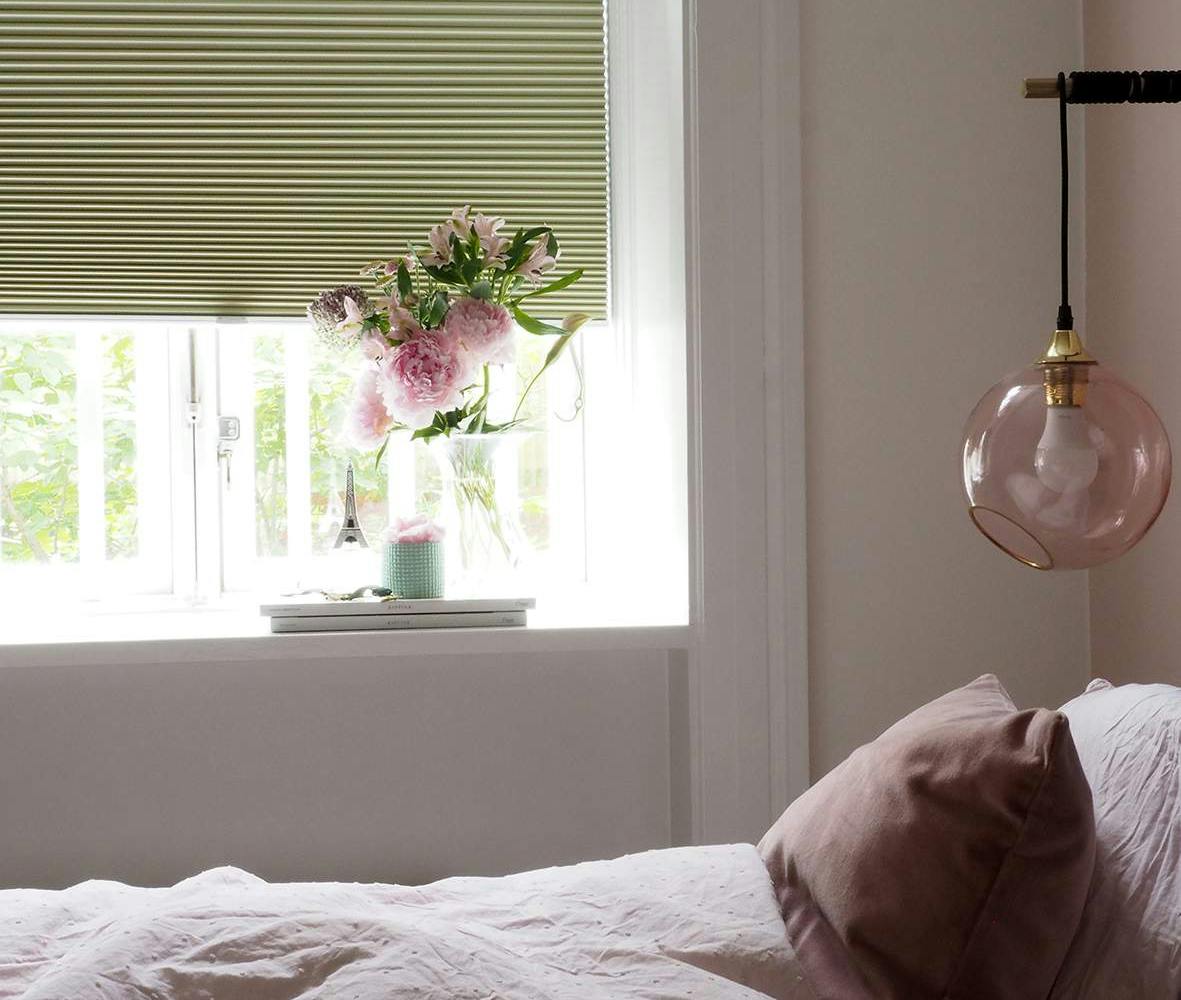 Green duette shades in a bedroom