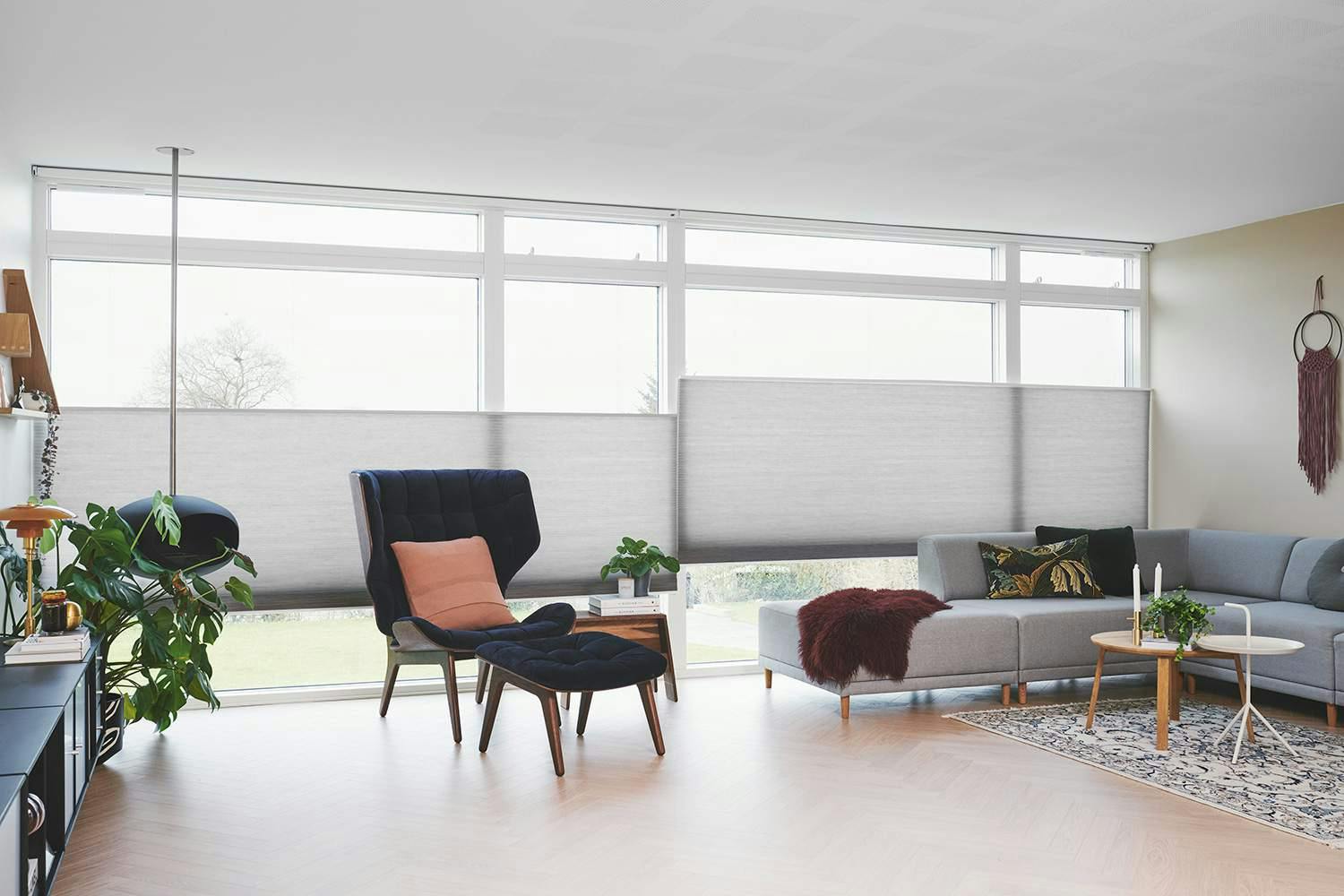 Maffiga Duette® gardiner i sober grå, i vardagsrumsfönster till ett intelligent hem