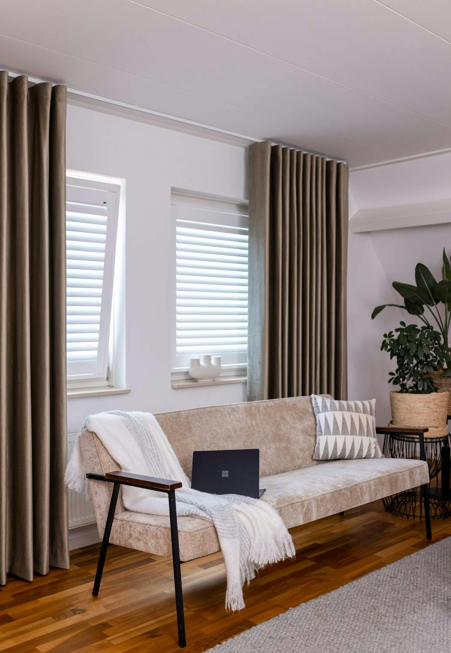 Layering van witte shutters en verduisterende gordijnen