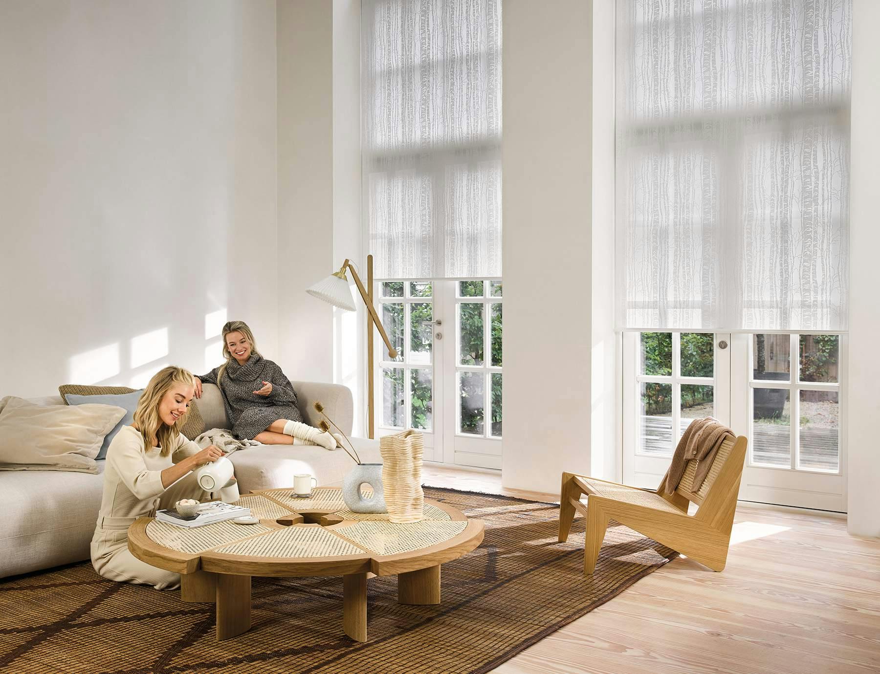 White roller blinds on large patio doors in a living room  
