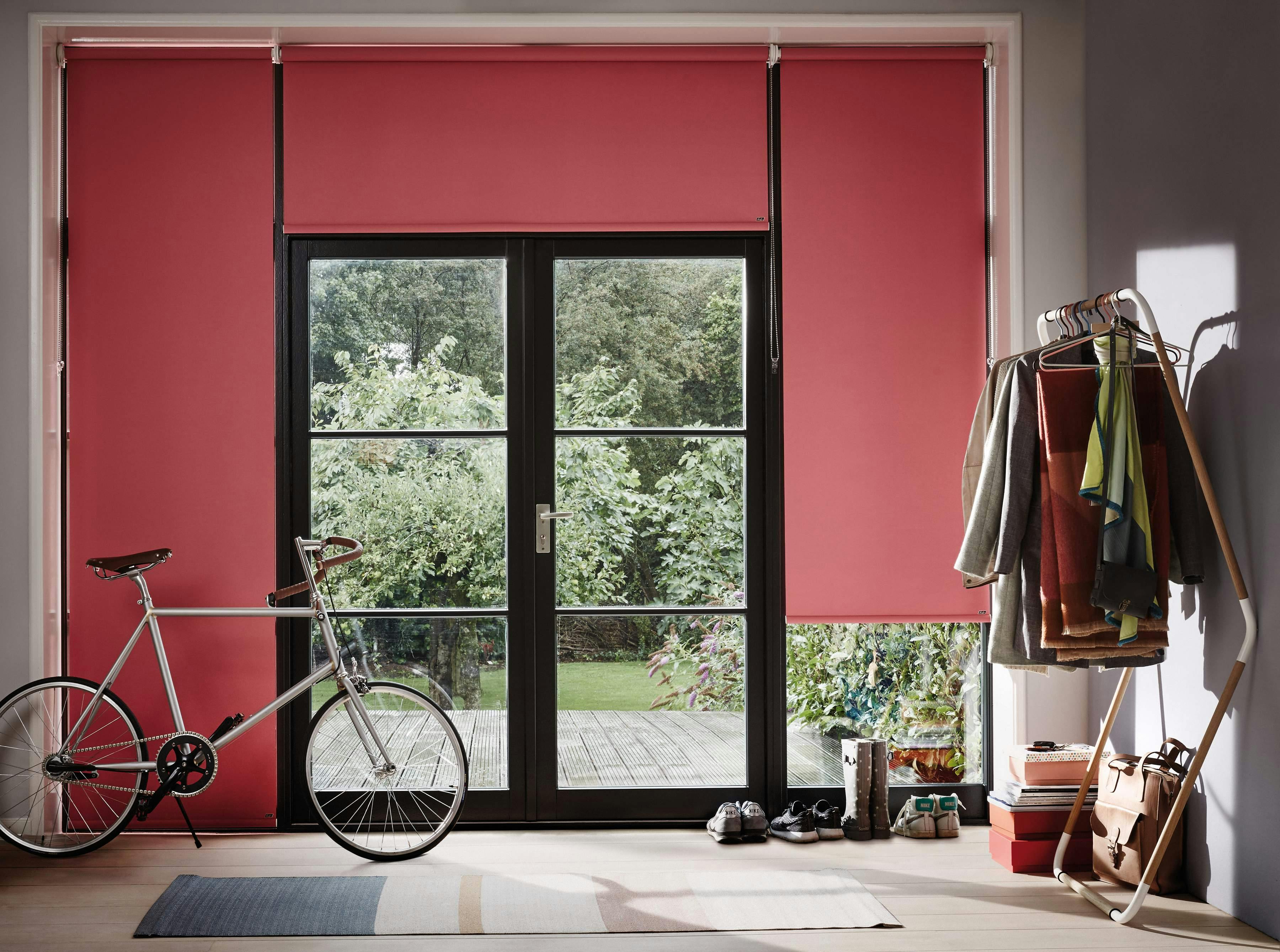  red roller blinds on patio doors in a hallway entrance