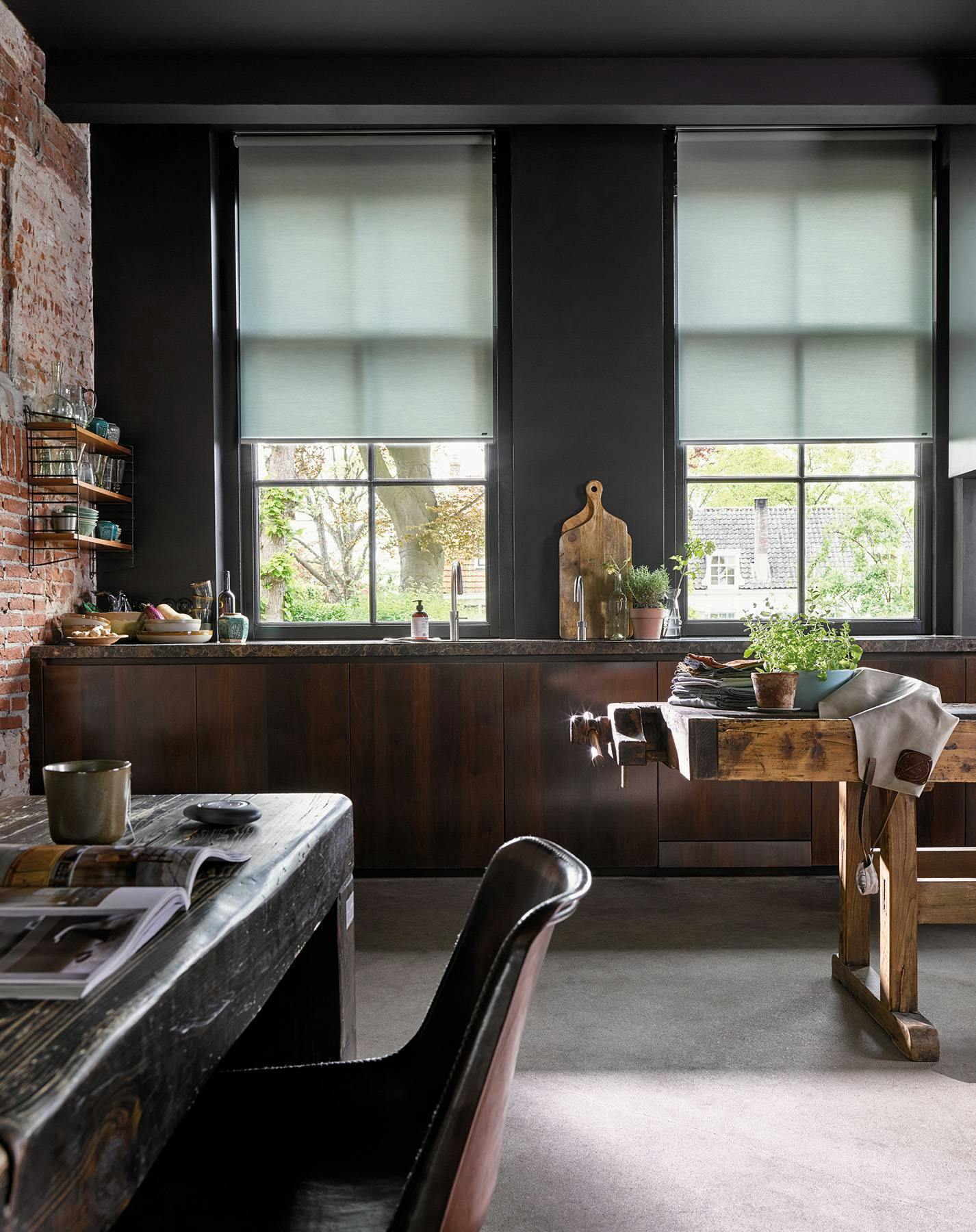 Teal roller blinds on a kitchen window