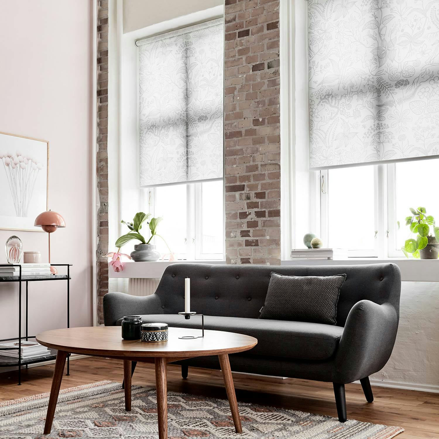 Light grey roller blinds in a living room 