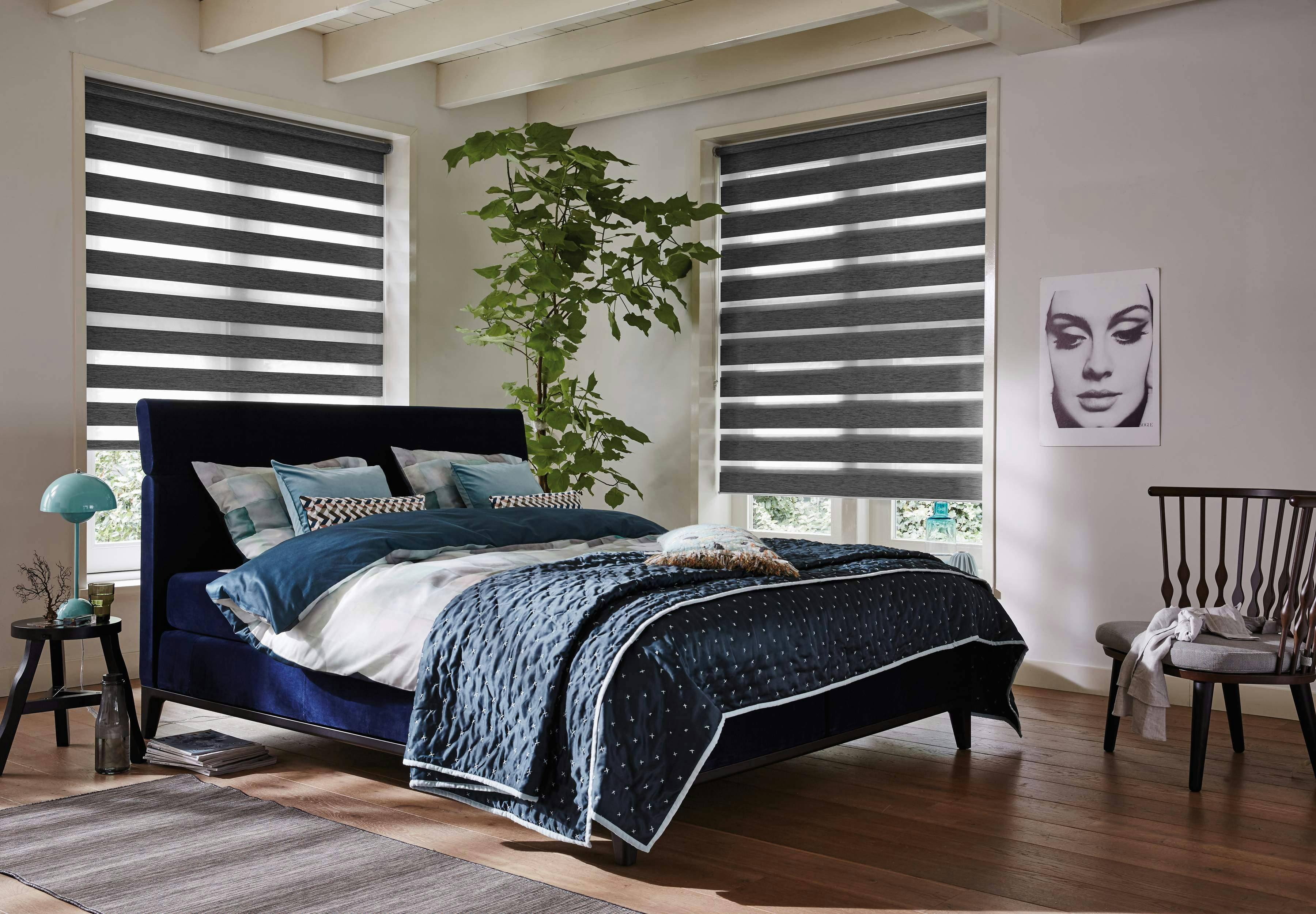 Dark grey duo roller blinds in a bedroom