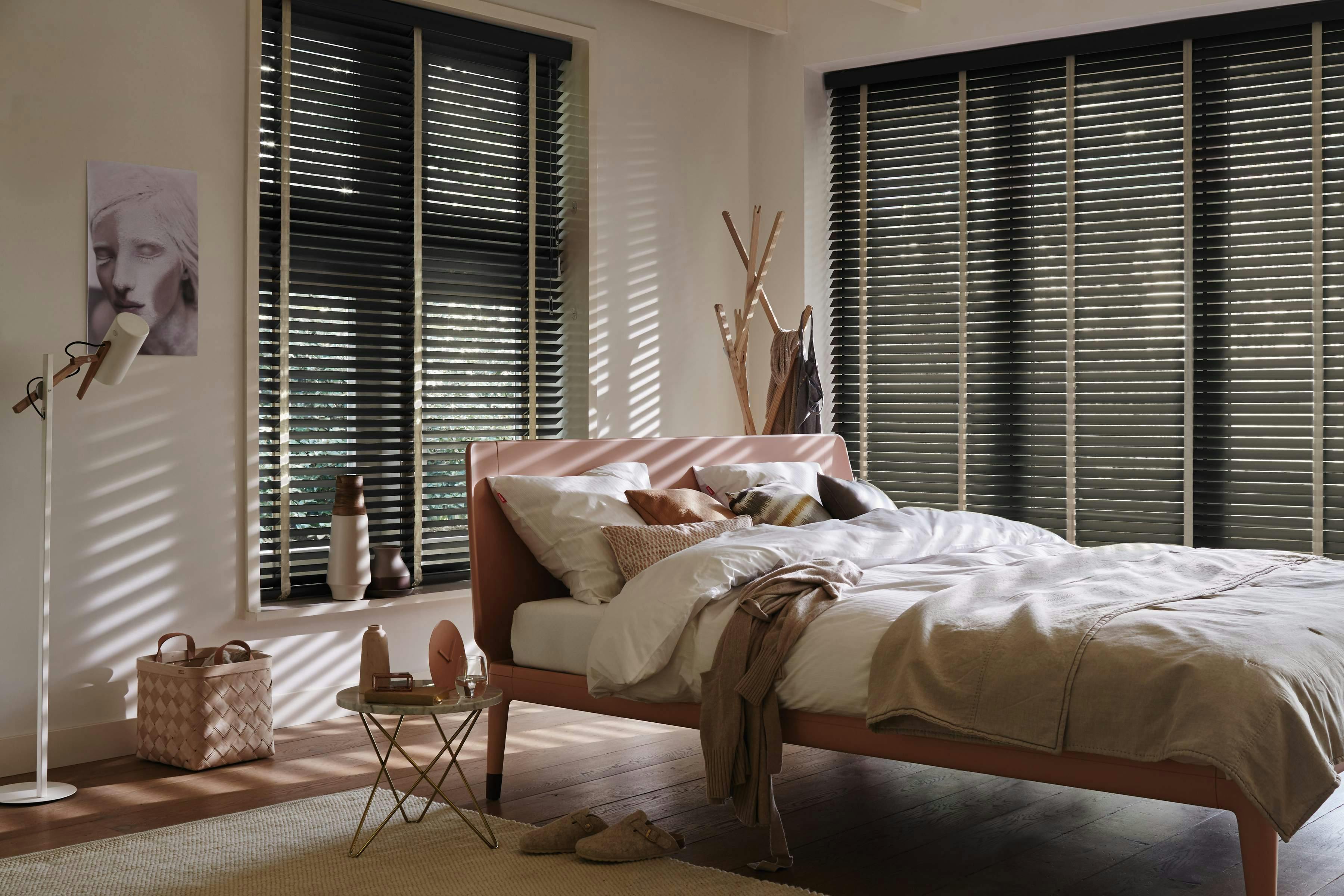Black wood blinds in a bedroom