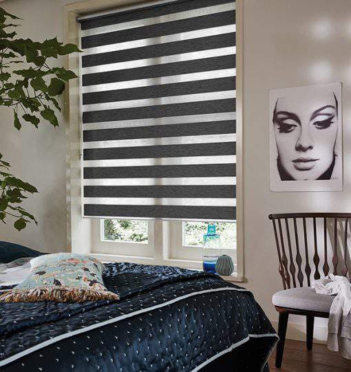 Dark grey duo roller blinds in a bedroom