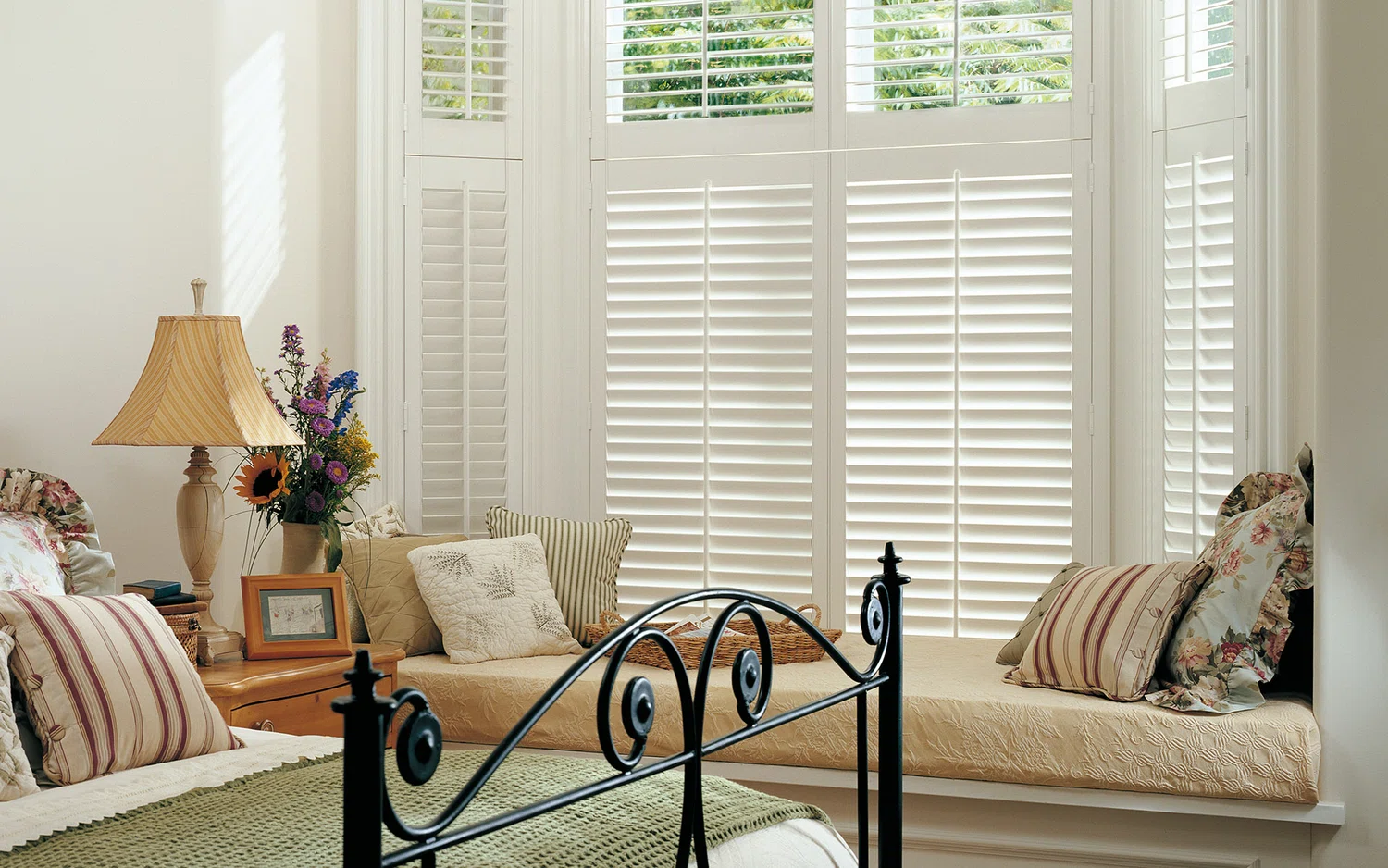 White tier on tier shutters in a bedroom 