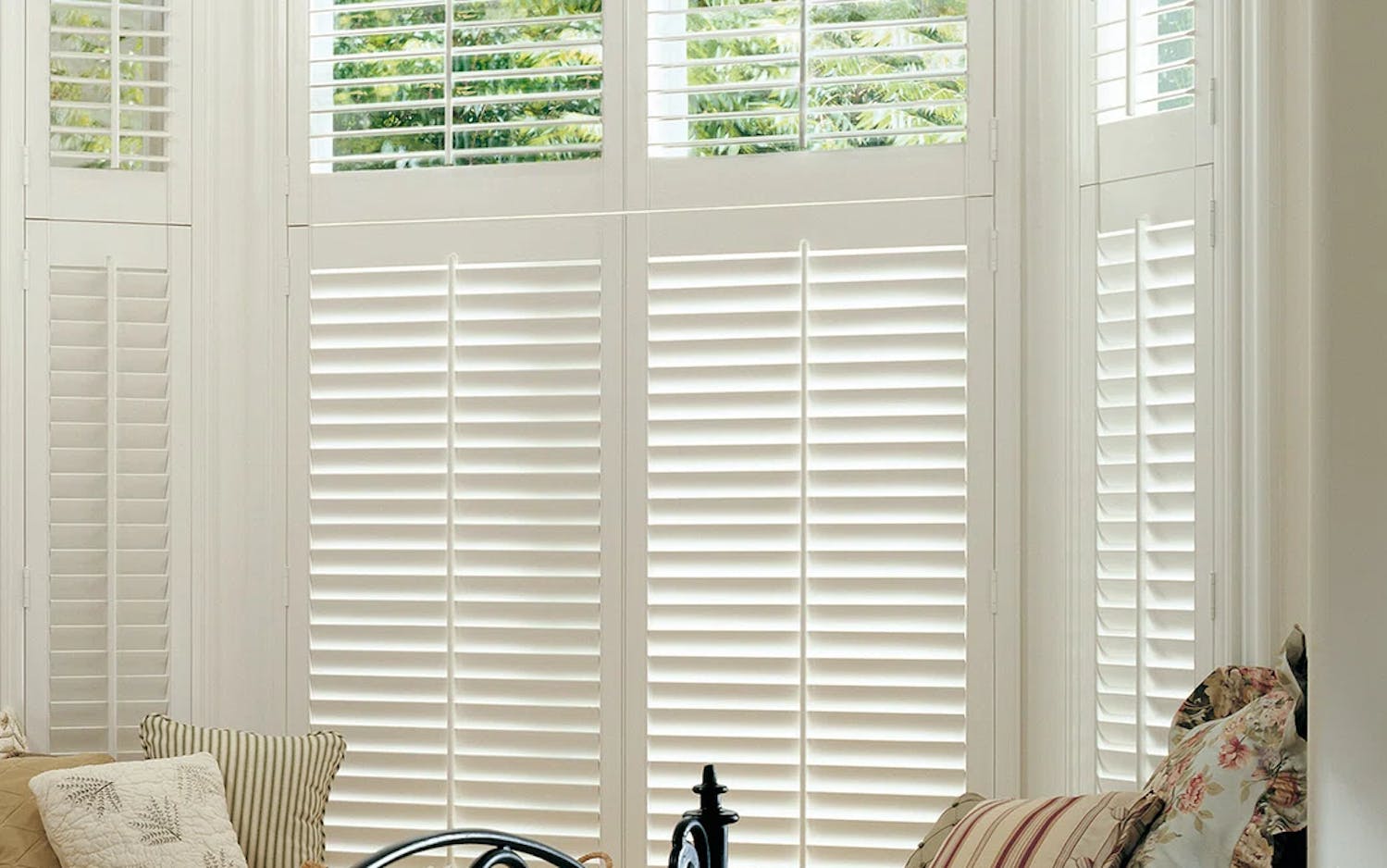 White tier on tier shutters in a bedroom