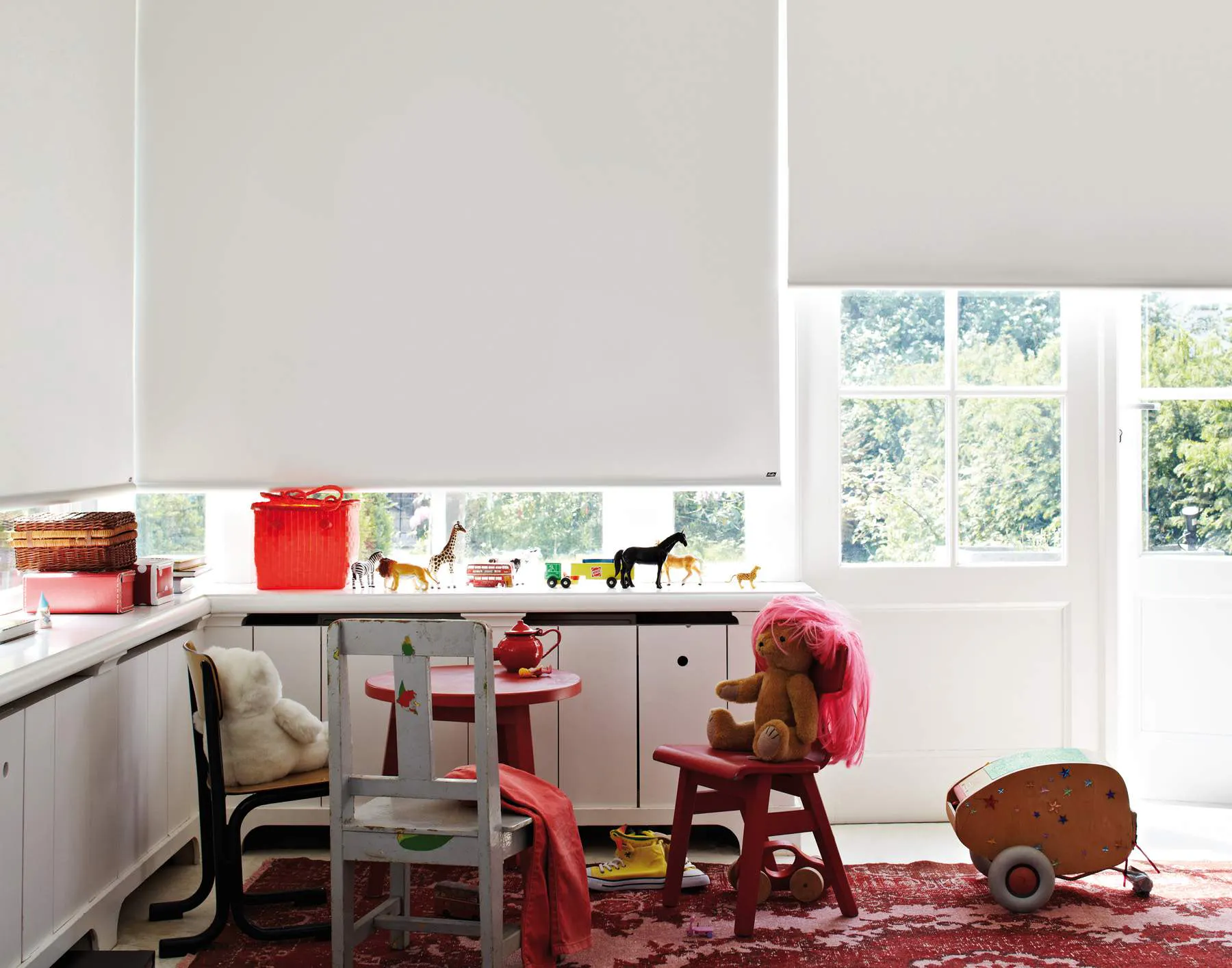 White roller blinds in a kids play room 