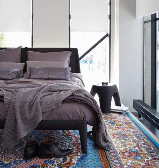 White roller blinds in a bedroom