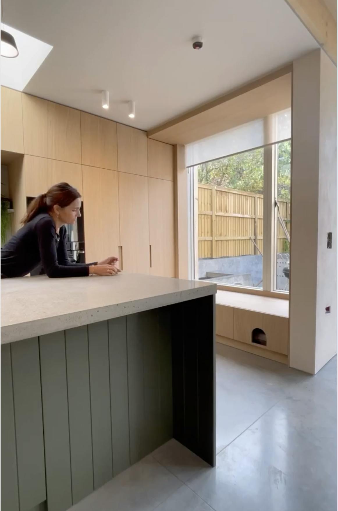 White roller blind in an open position on a real home kitchen