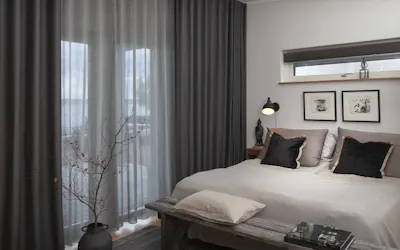 Grey curtains in sheer and blackout material in a bedroom