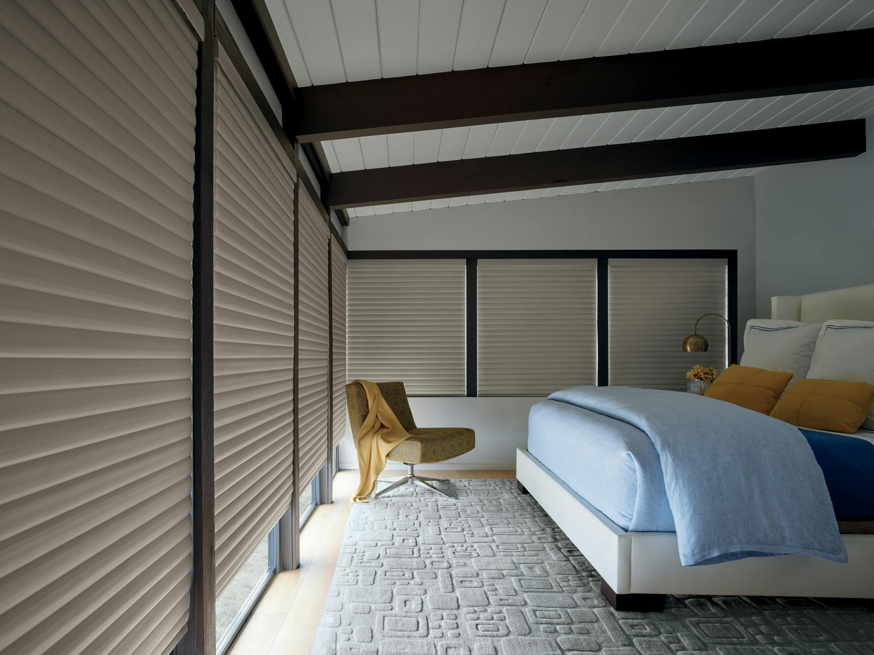 Grey sonnette shades in a bedroom 