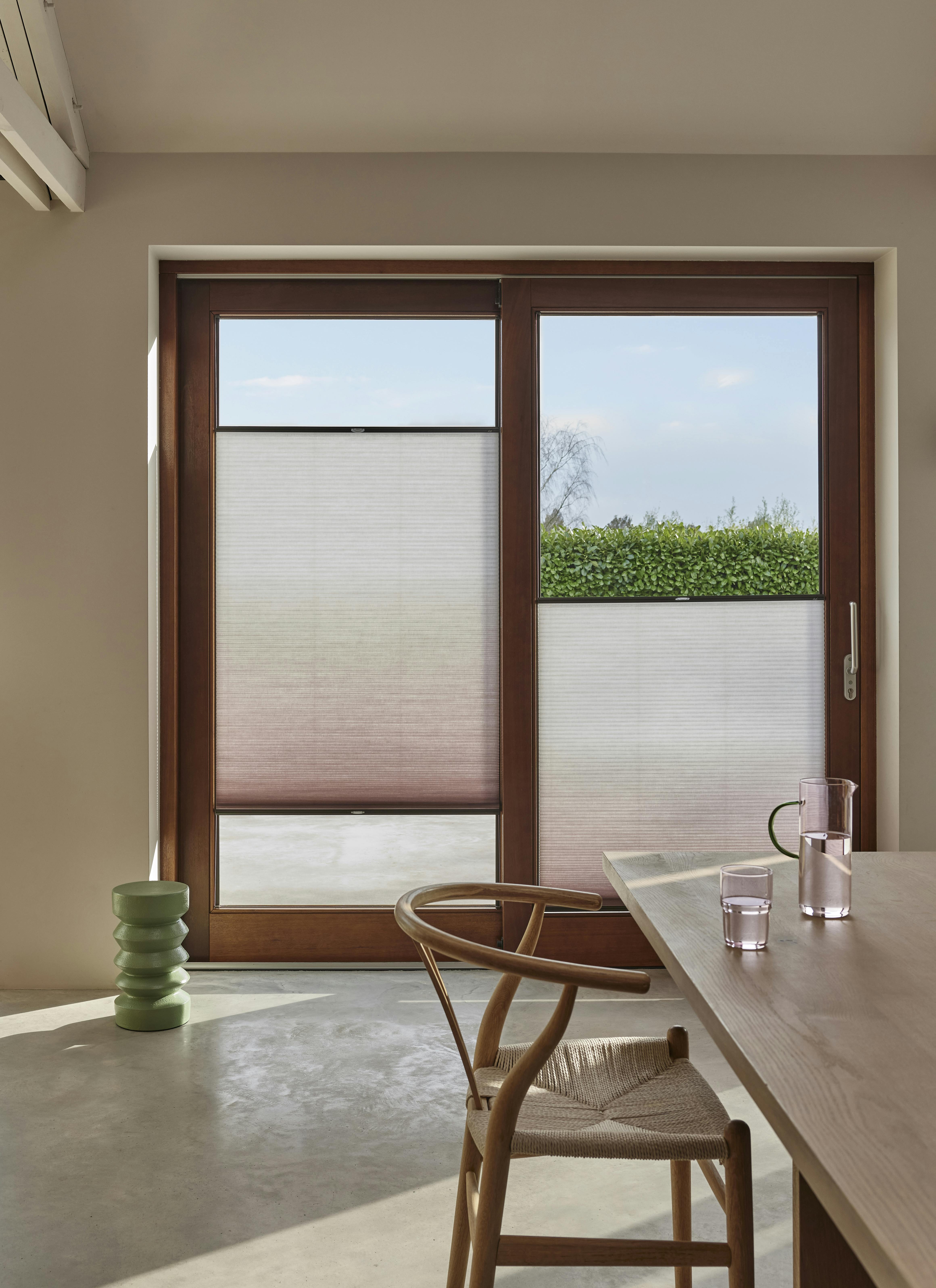 Gradient pink duette shades on patio doors  