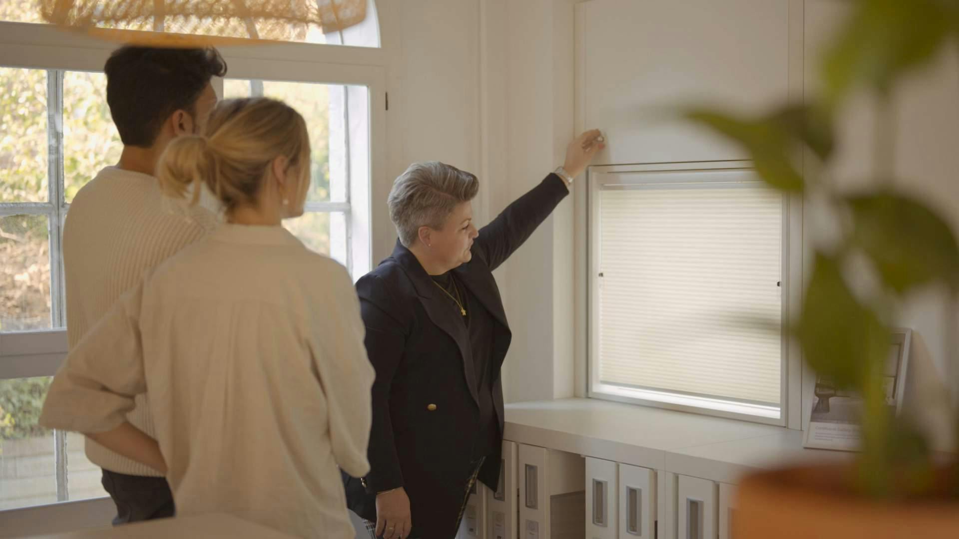 Customers visiting a showroom with a white duette display