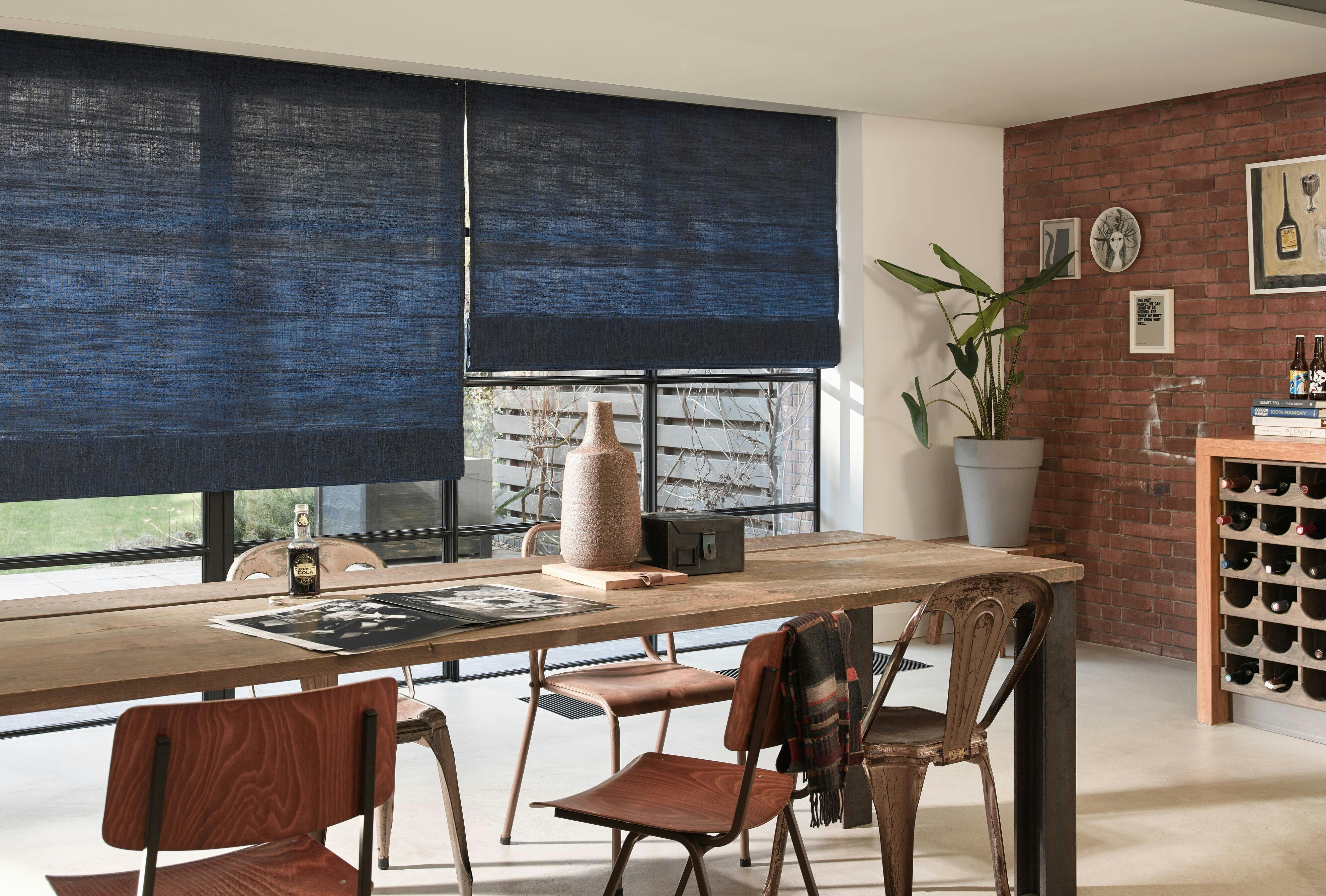 Semi-translucent dark blue roman blinds in a dining room
