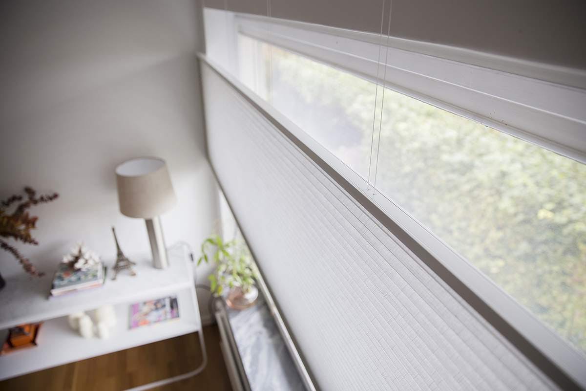 White top down bottom up blinds covering a living room window