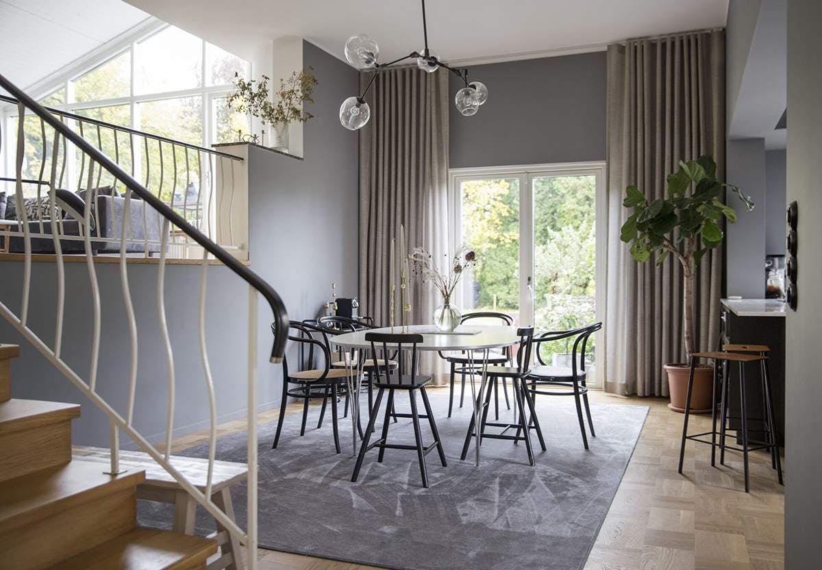 Dining room with curtains covering large patio doors