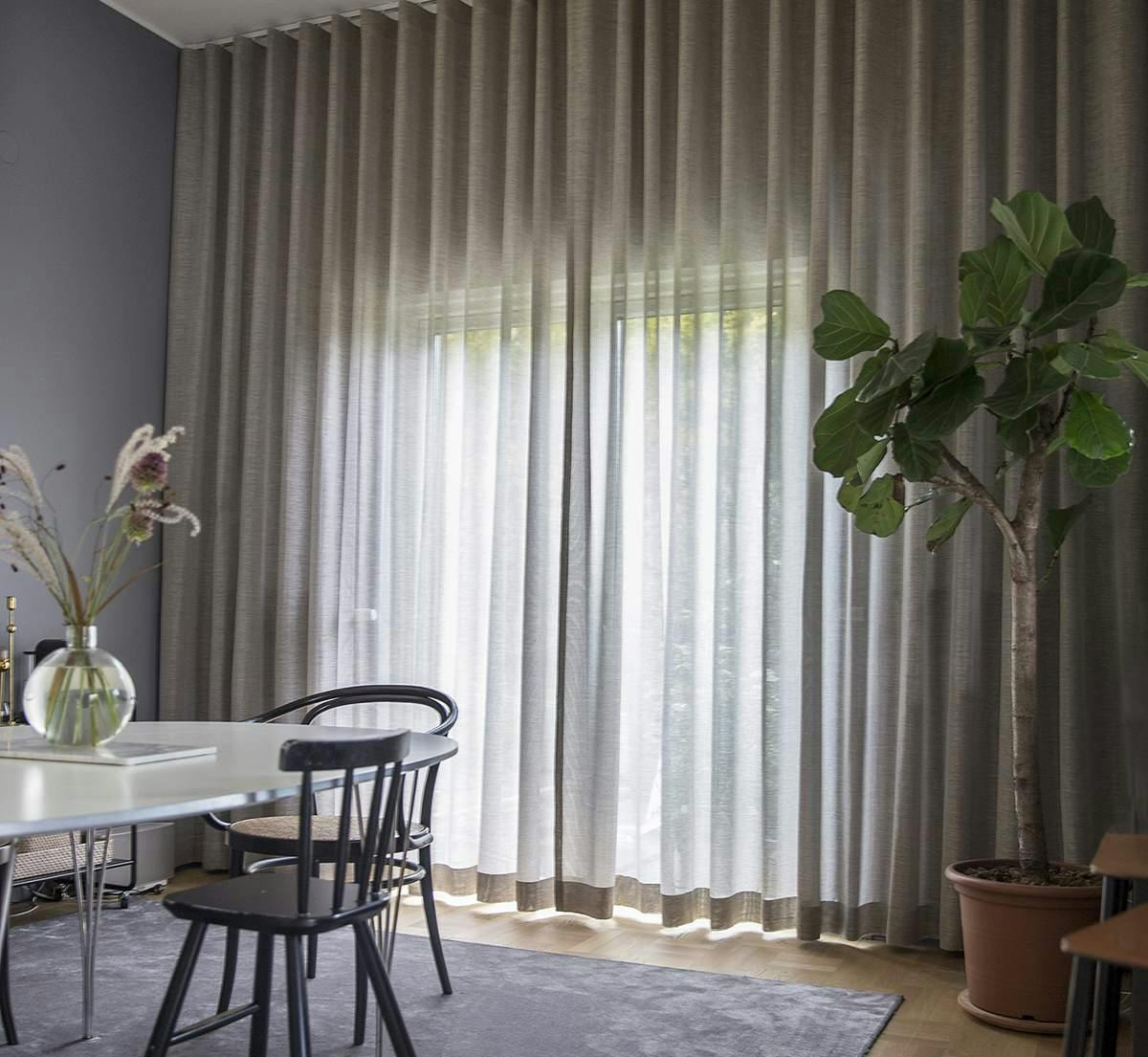 Floor to ceiling sheer curtains covering patio doors