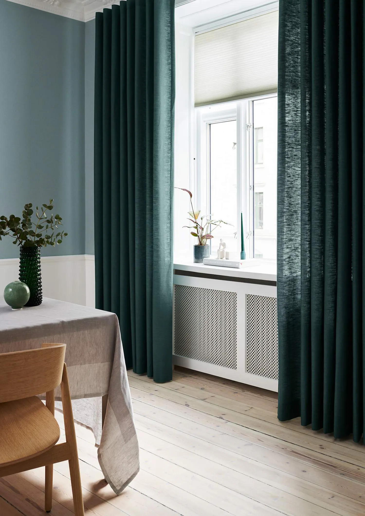 Teal curtains covering dining room windows