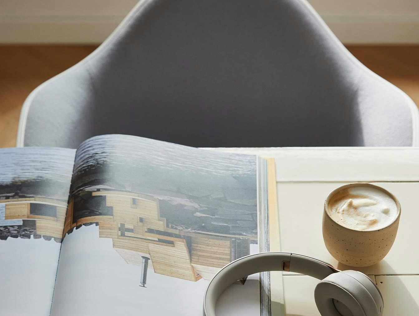 Close up of a desk with headphones and book open