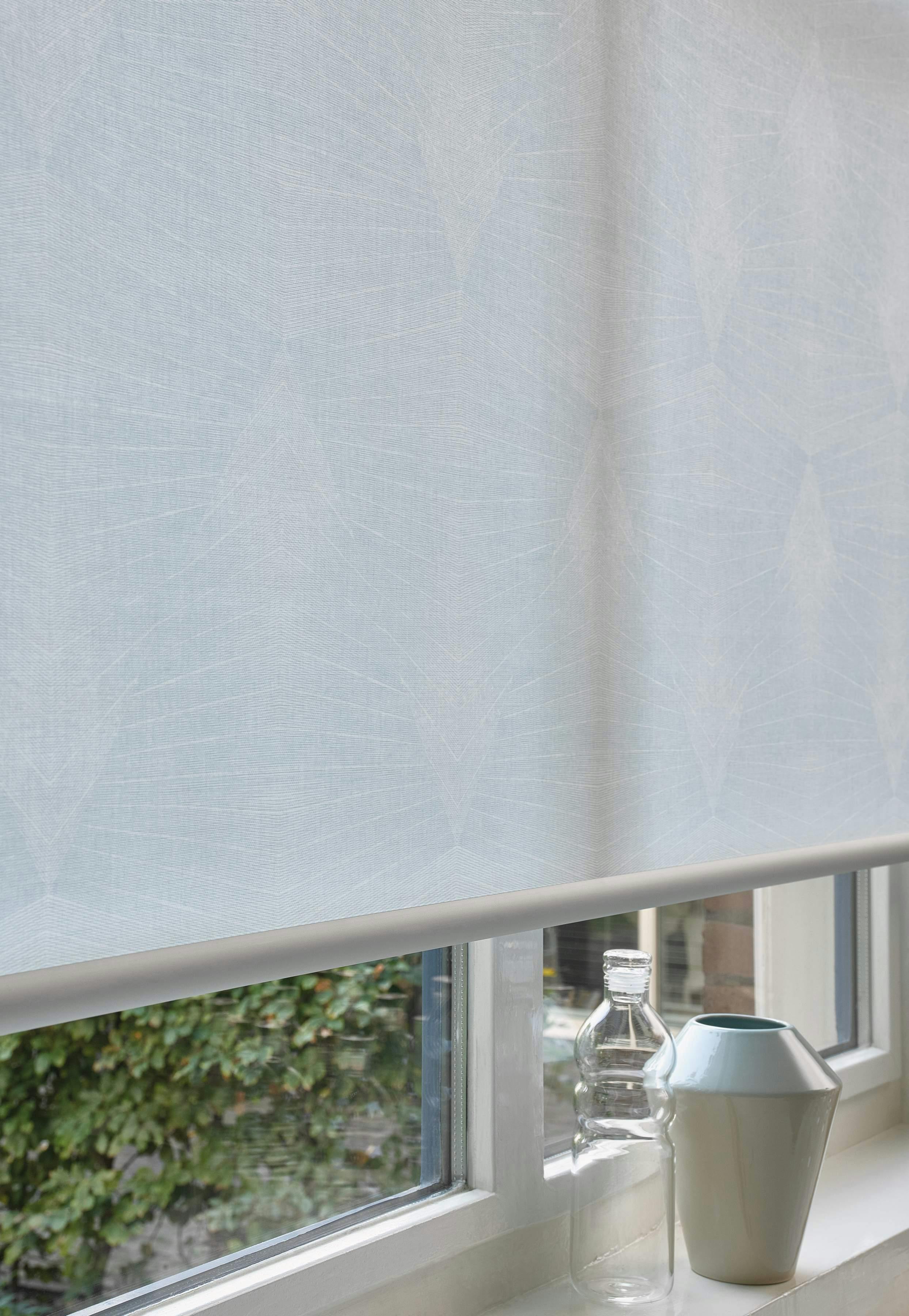 Patterned light blue luxaflex roller blind 