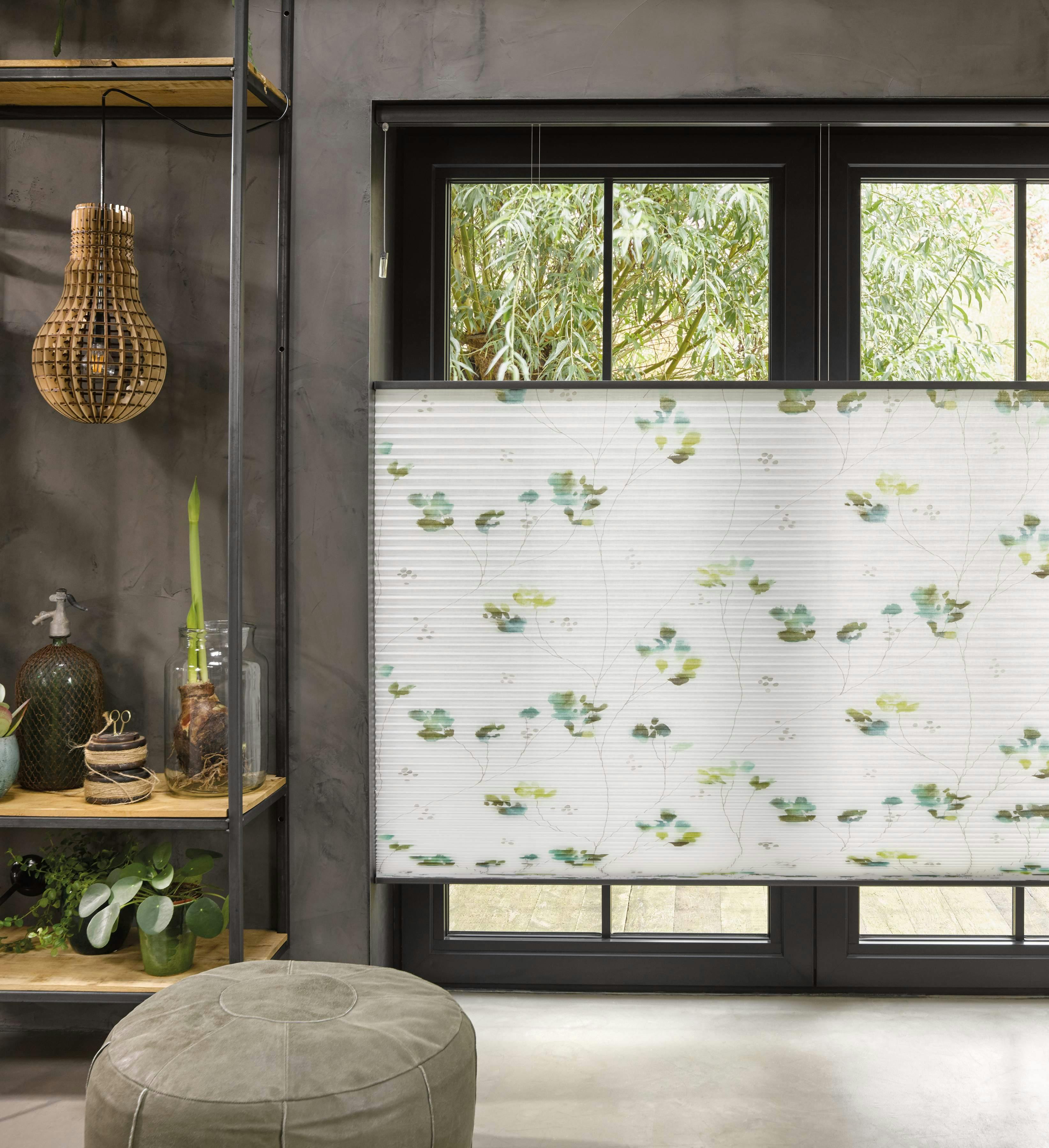 Patterned white duette blinds covering patio doors in a living room