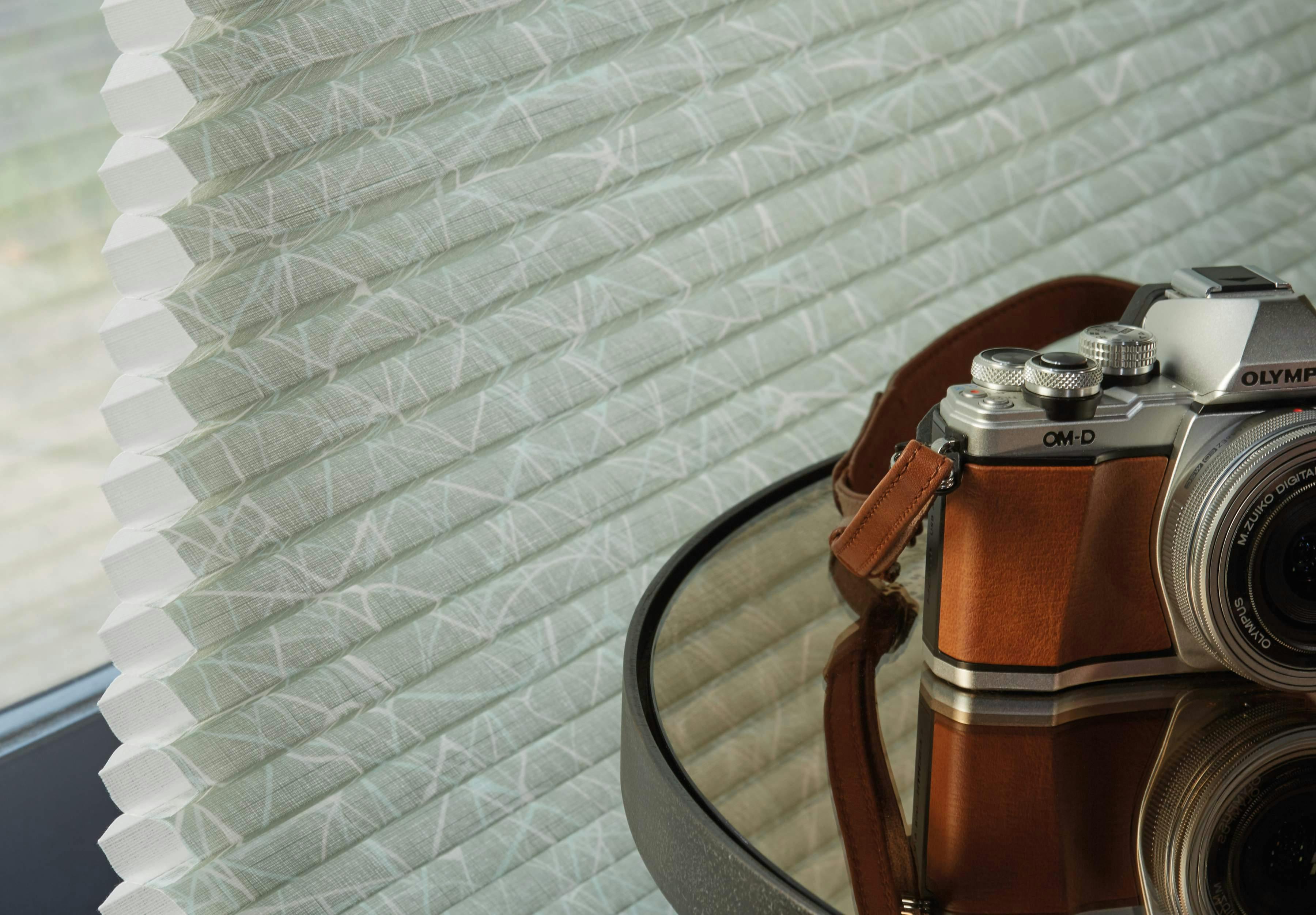 Green patterned duette blinds close up