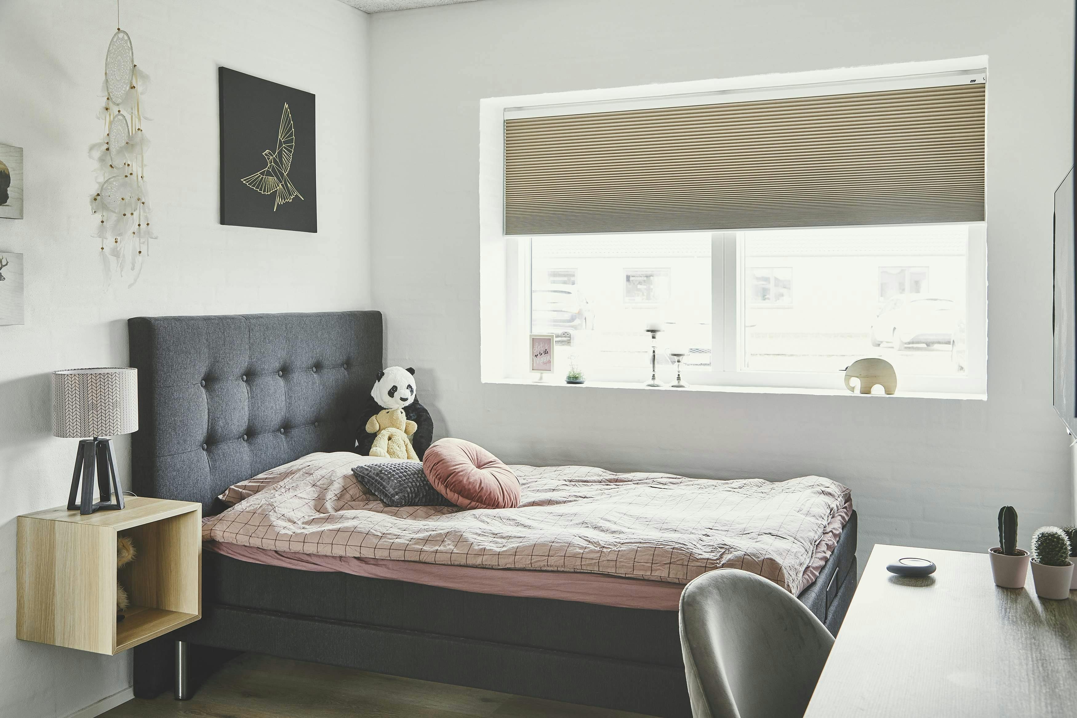 Brown blackout duette blinds covering a bedroom window