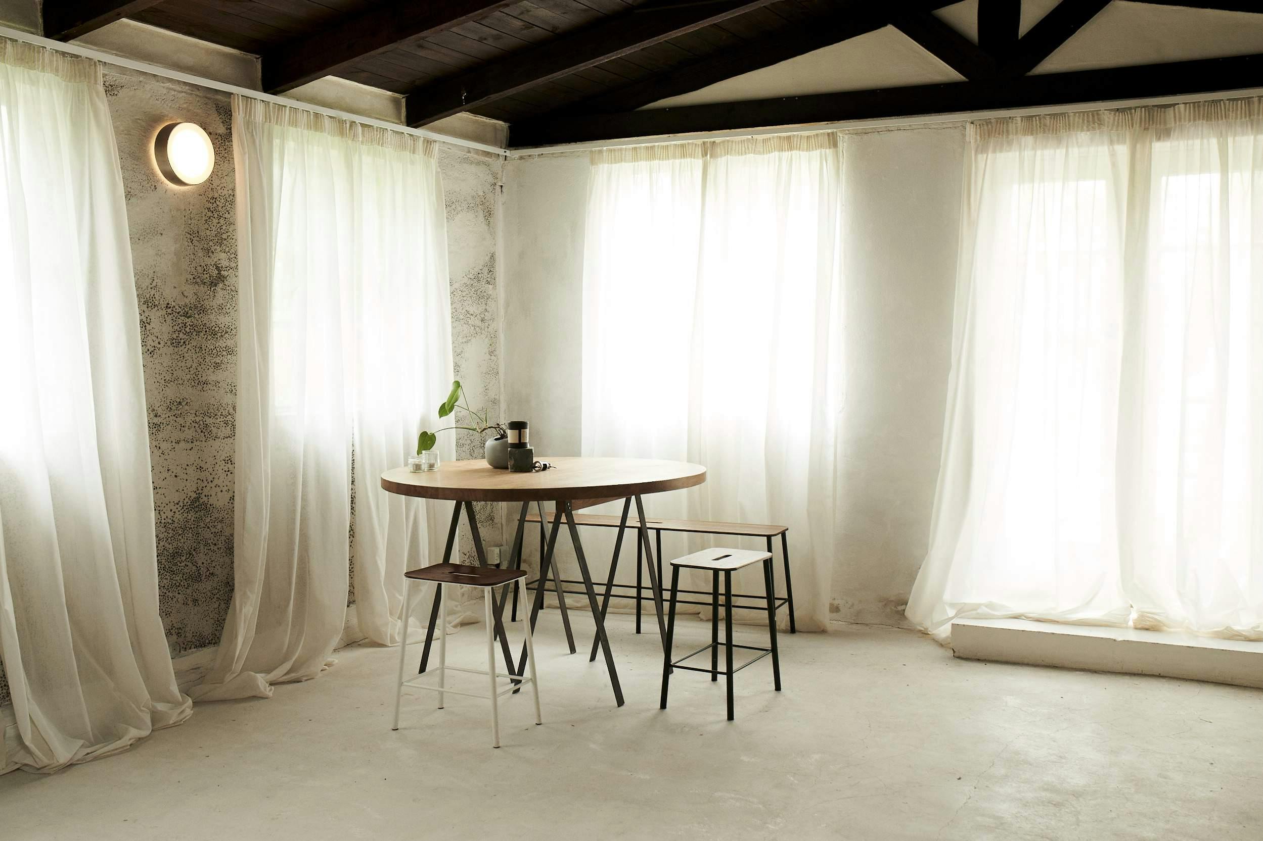 Dining room with long white sheer curtain providing privacy