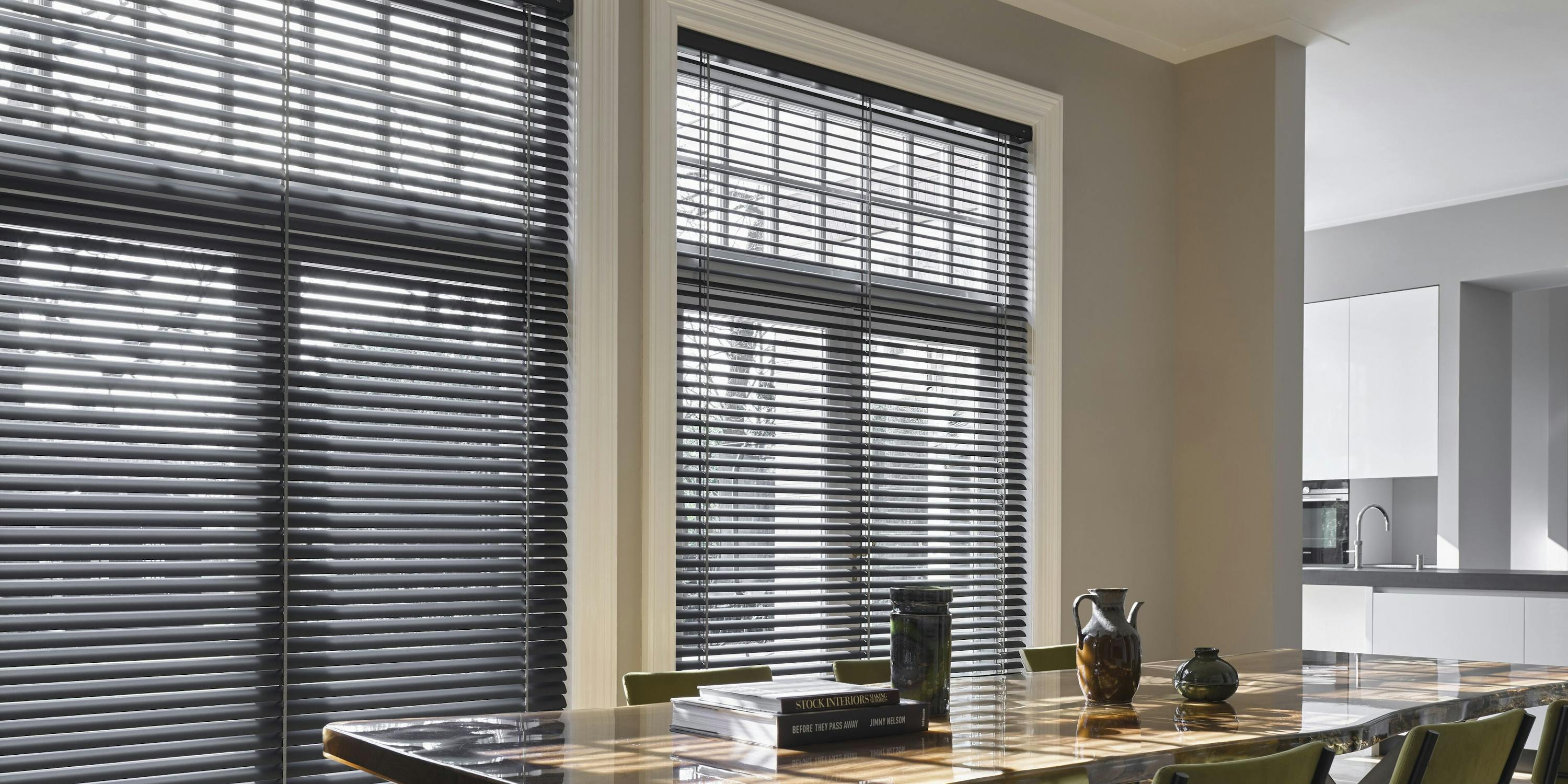 Black venetian blinds in full height kitchen dining room windows